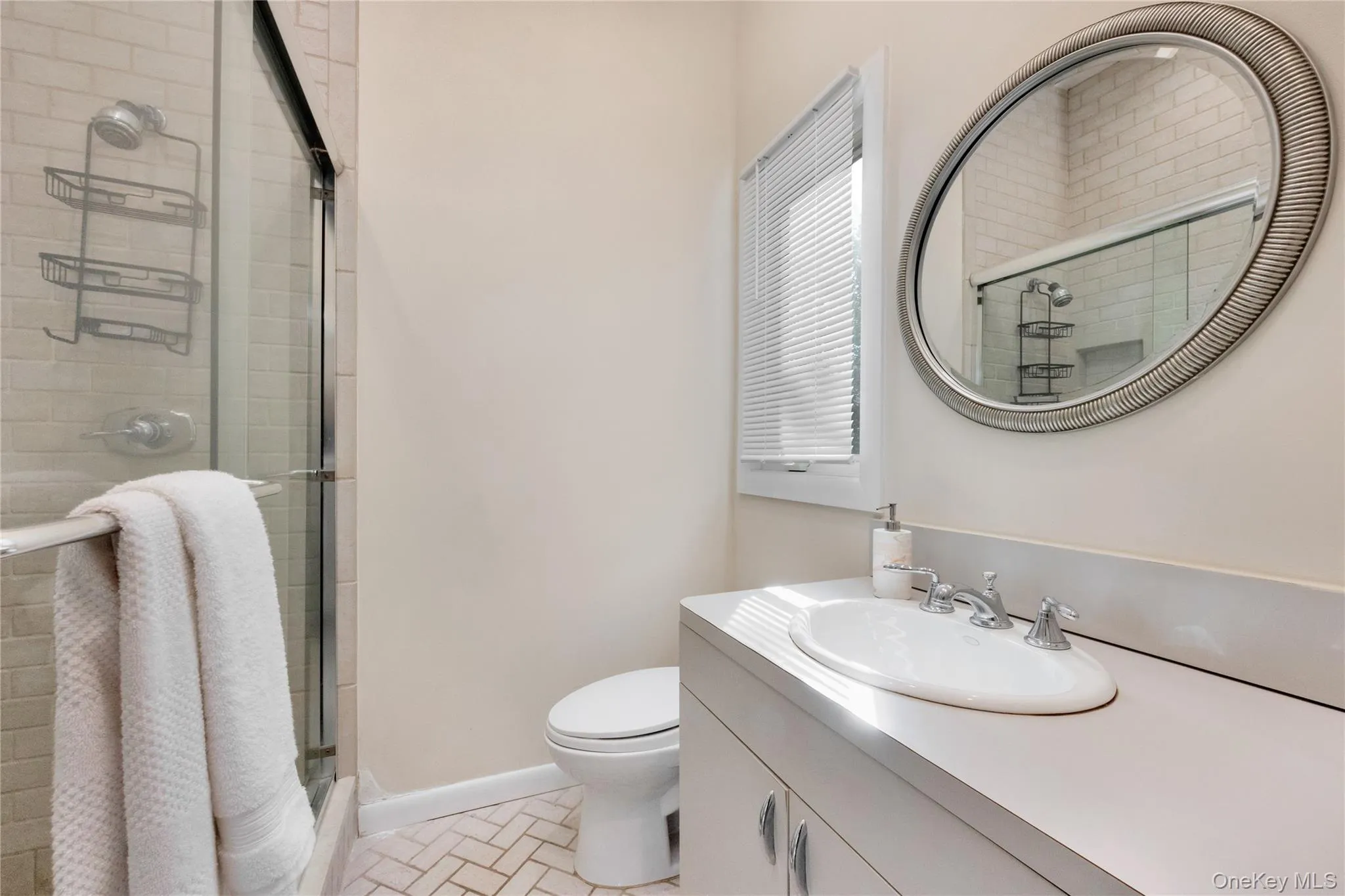 Bathroom featuring toilet, a stall shower, baseboards, and vanity Bathroom featuring toilet, a stall shower, baseboards, and vanity