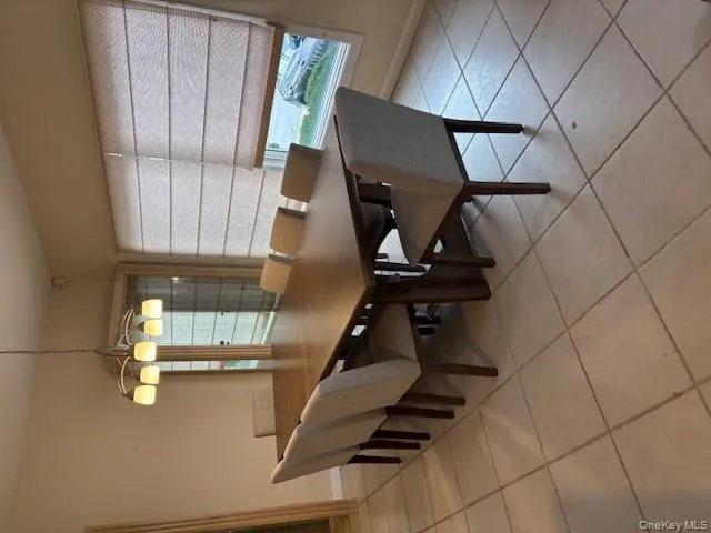 Dining room featuring light tile patterned flooring and baseboards Dining room featuring light tile patterned flooring and baseboards
