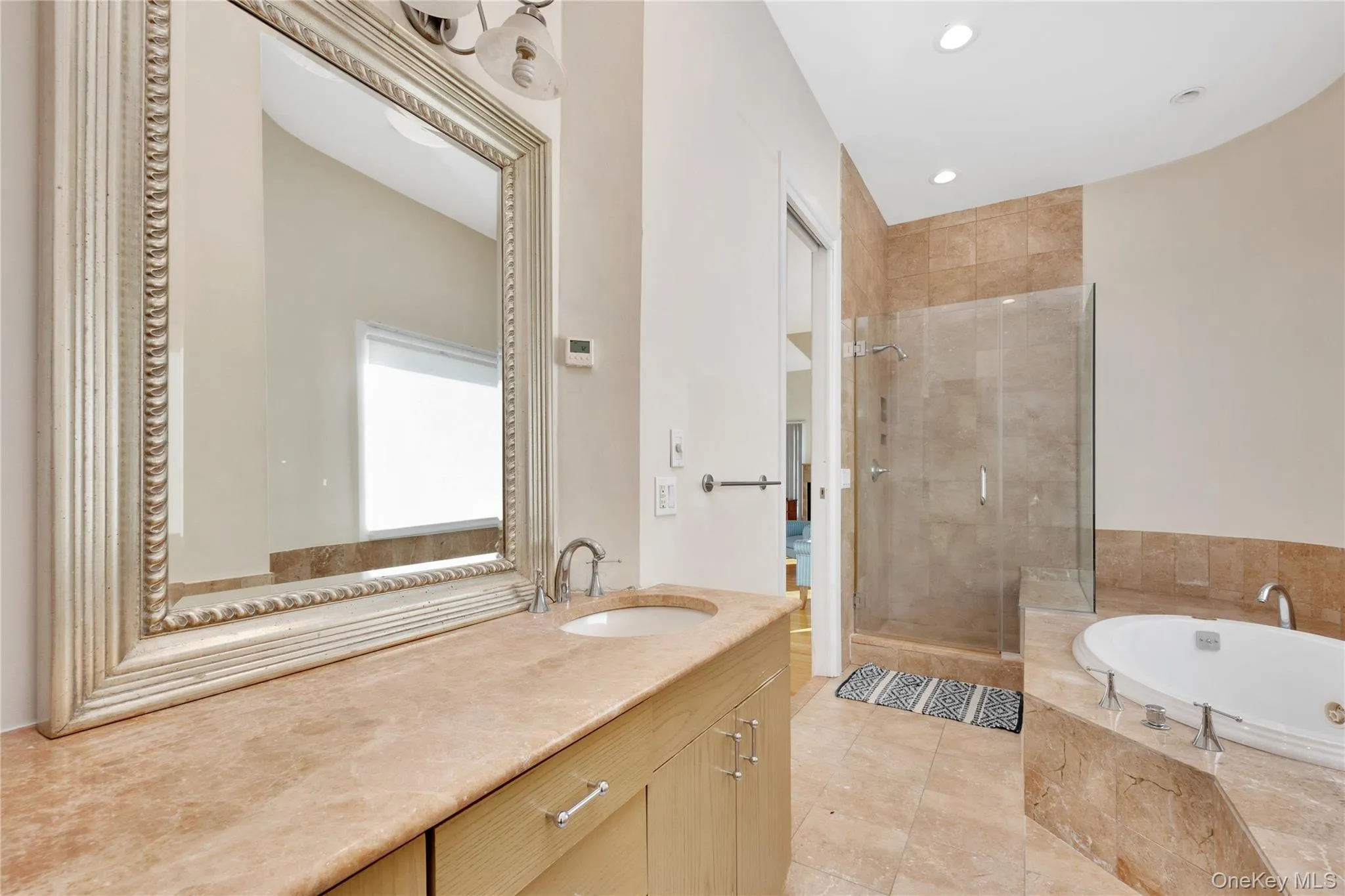 Bathroom with a stall shower, vanity, recessed lighting, and a bath Bathroom with a stall shower, vanity, recessed lighting, and a bath