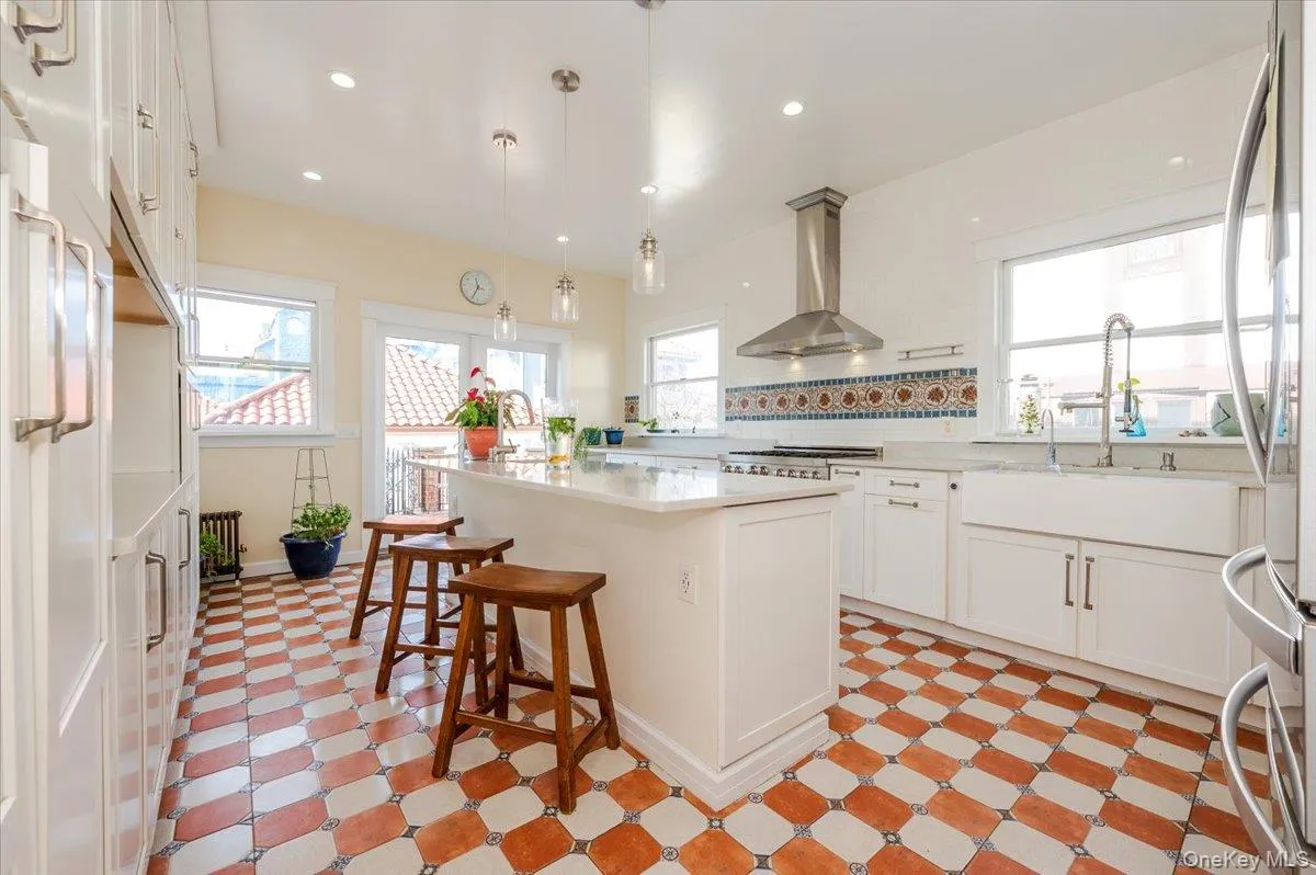 Large new eat in Kitchen with an island, quartz countertops, pro line appliances, tile floors, and white cabinetry Large new eat in Kitchen with an island, quartz countertops, pro line appliances, tile floors, and white cabinetry