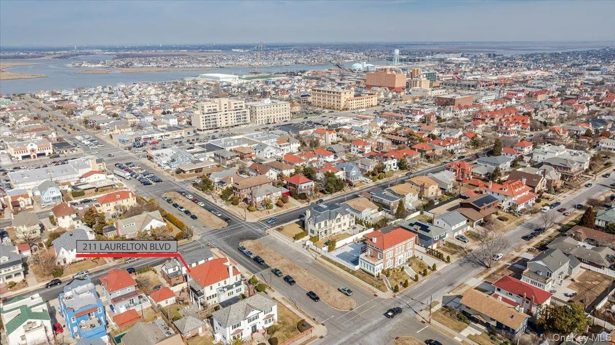 Birds eye view of property with a water view and a view of city Birds eye view of property with a water view and a view of city
