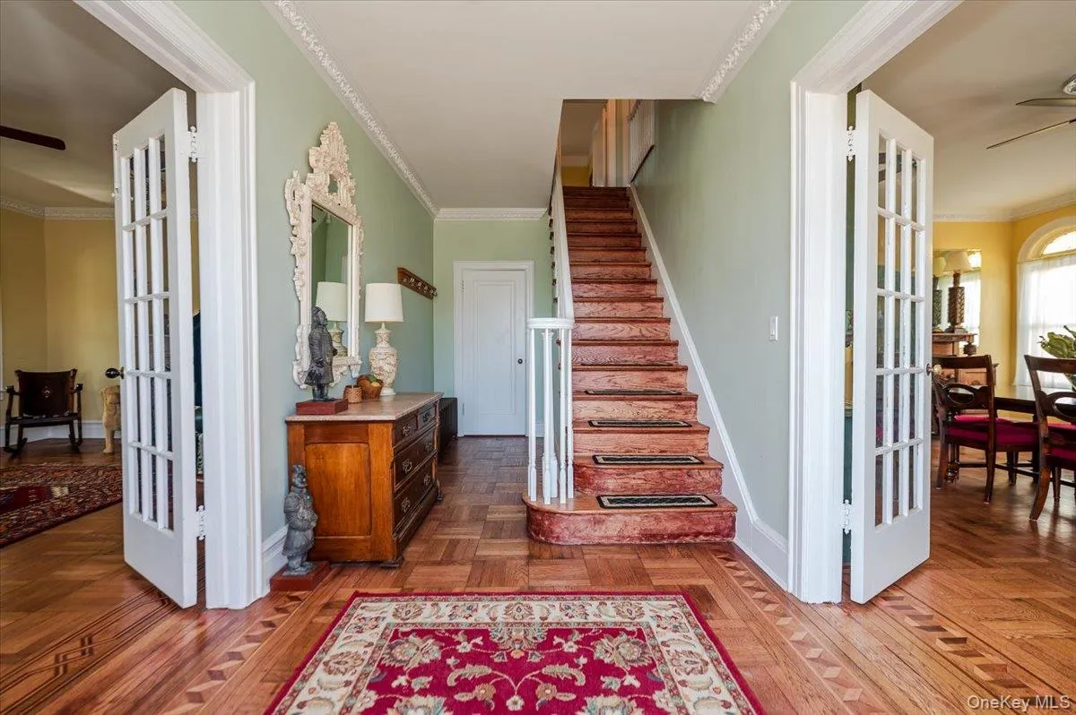 Formal Entry Foyer, Stairway with french doors to LR & DRs, custom inlaid marquetry floors, crown molding Formal Entry Foyer, Stairway with french doors to LR & DRs, custom inlaid marquetry floors, crown molding