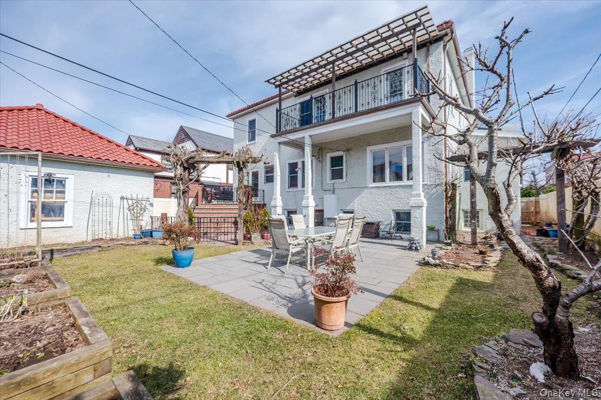 Back of house with a patio, a balcony, fence, a tiled roof, and stucco siding Back of house with a patio, a balcony, fence, a tiled roof, and stucco siding