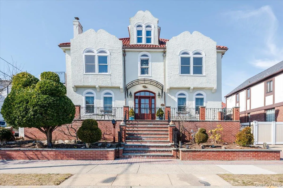 View of front of Historic, yet fully updated home featuring a red tile roof, fence, and stucco siding View of front of Historic, yet fully updated home featuring a red tile roof, fence, and stucco siding