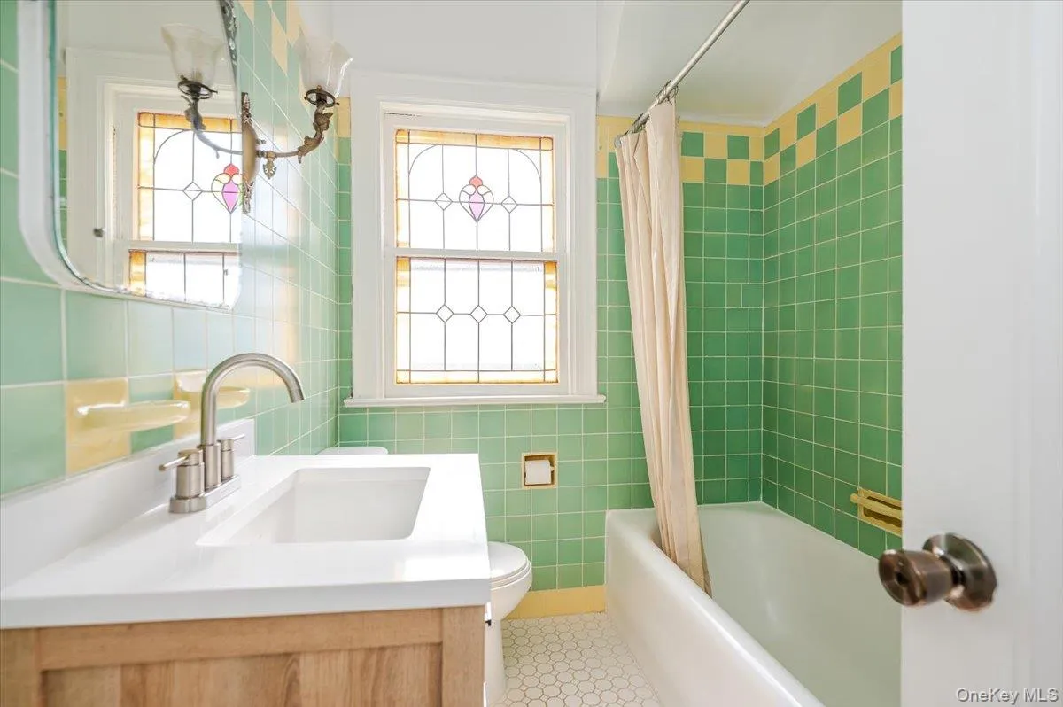 Updated 2nd floor Hall Bathroom featuring shower/bath combo, tile patterned floors and new vanity Updated 2nd floor Hall Bathroom featuring shower/bath combo, tile patterned floors and new vanity