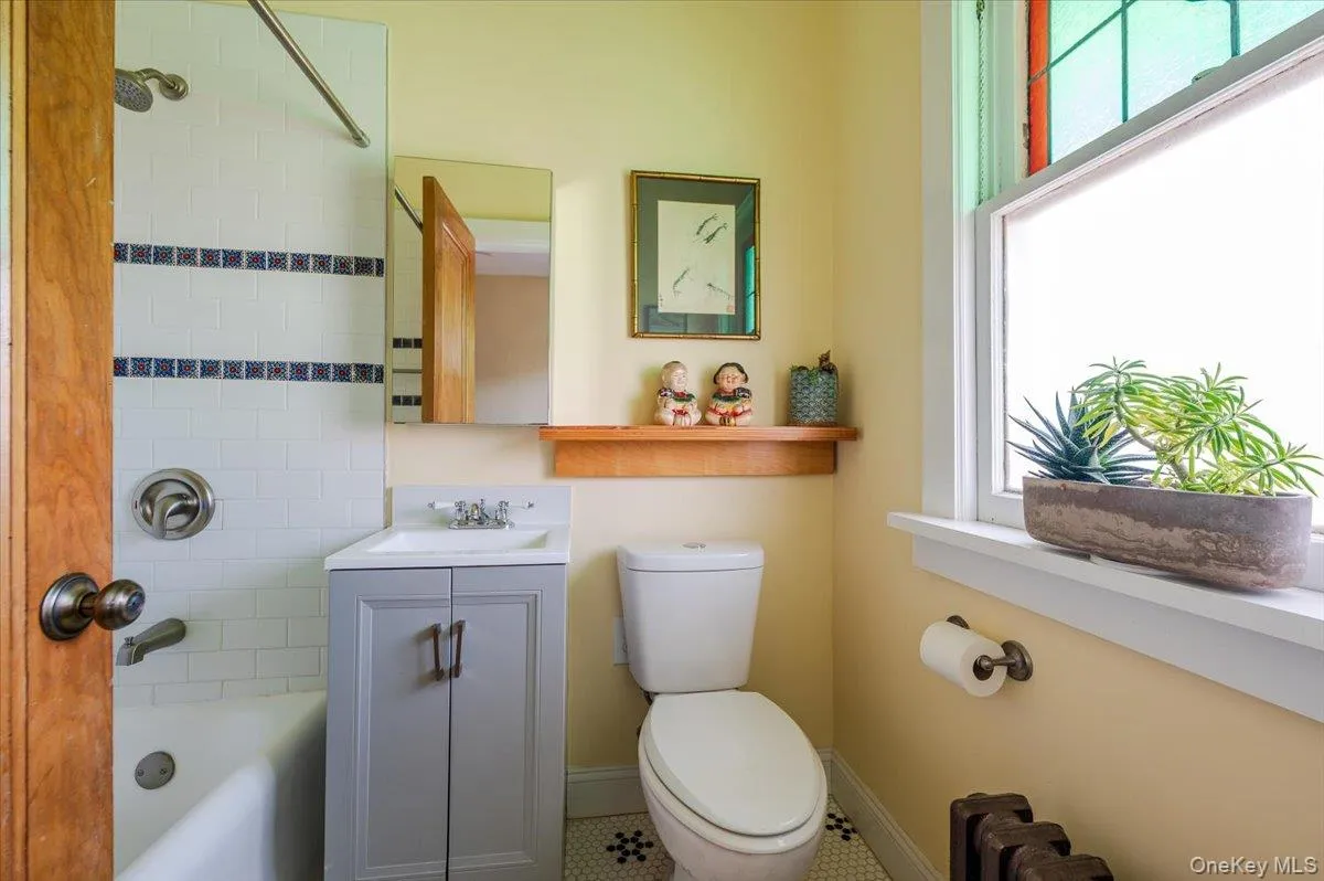 Main floor Office/Bedroom Bathroom featuring a wealth of natural light and shower/tub combination Main floor Office/Bedroom Bathroom featuring a wealth of natural light and shower/tub combination