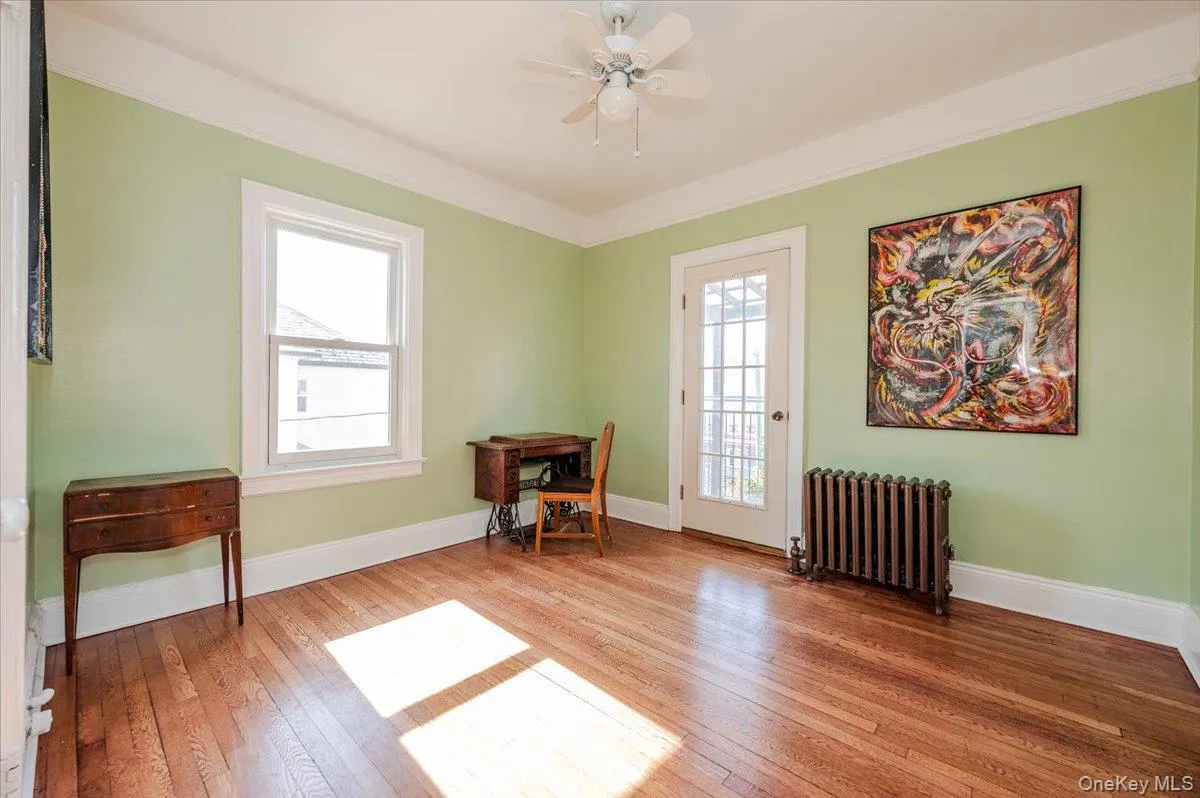 Bright bedroom with hardwood floors and terrace access Bright bedroom with hardwood floors and terrace access