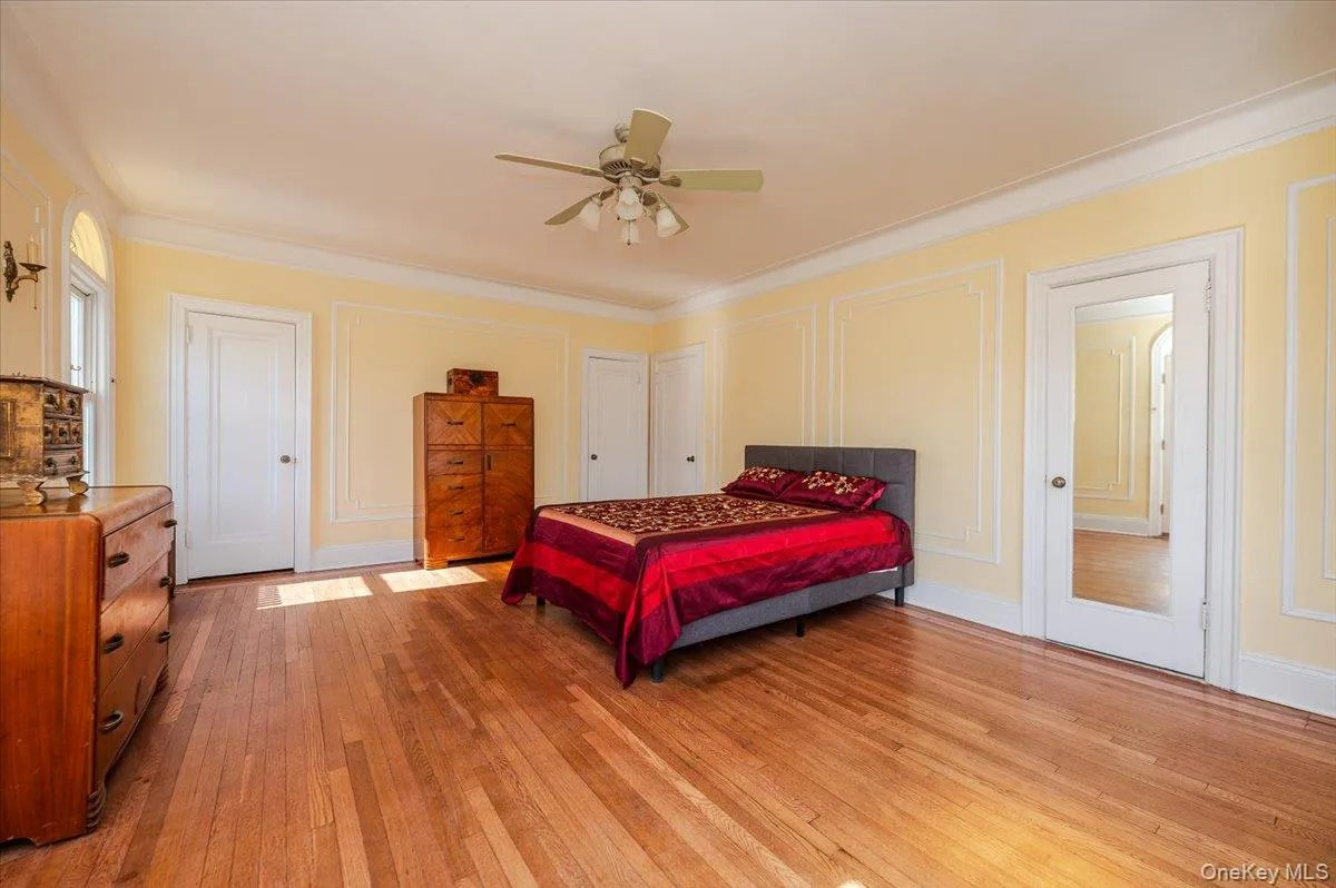 Large & Bright Primary Bedroom w wood flooring, a ceiling fan, ensuite full bath, and access to private south facing oceanview terrace Large & Bright Primary Bedroom w wood flooring, a ceiling fan, ensuite full bath, and access to private south facing oceanview terrace