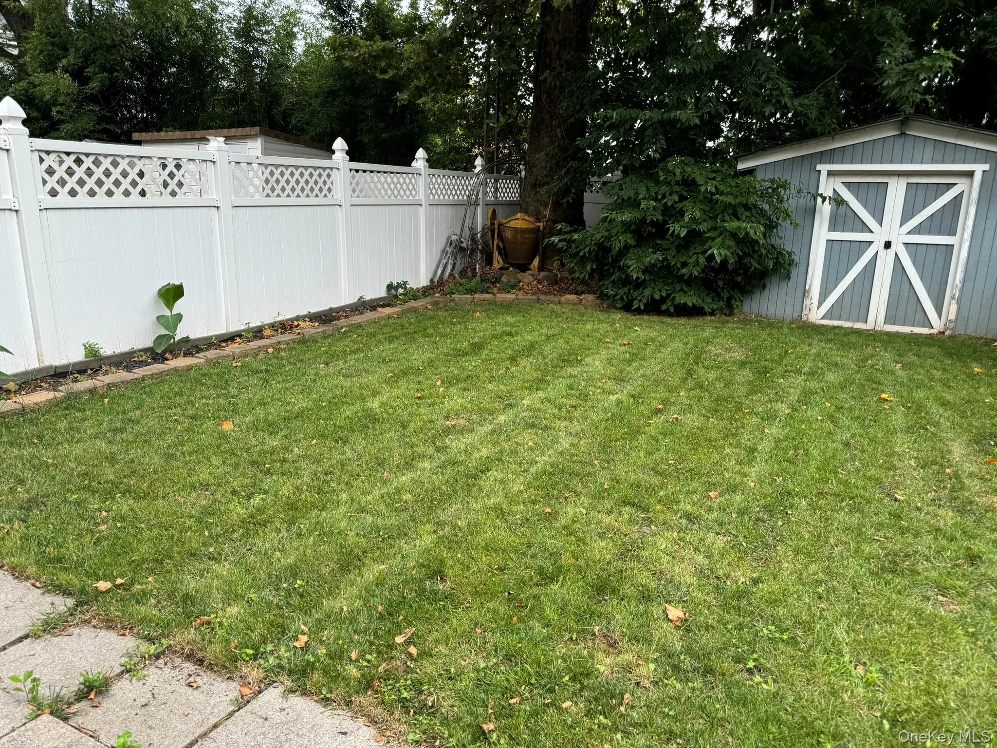 View of yard featuring an outbuilding, a storage unit, and fence View of yard featuring an outbuilding, a storage unit, and fence