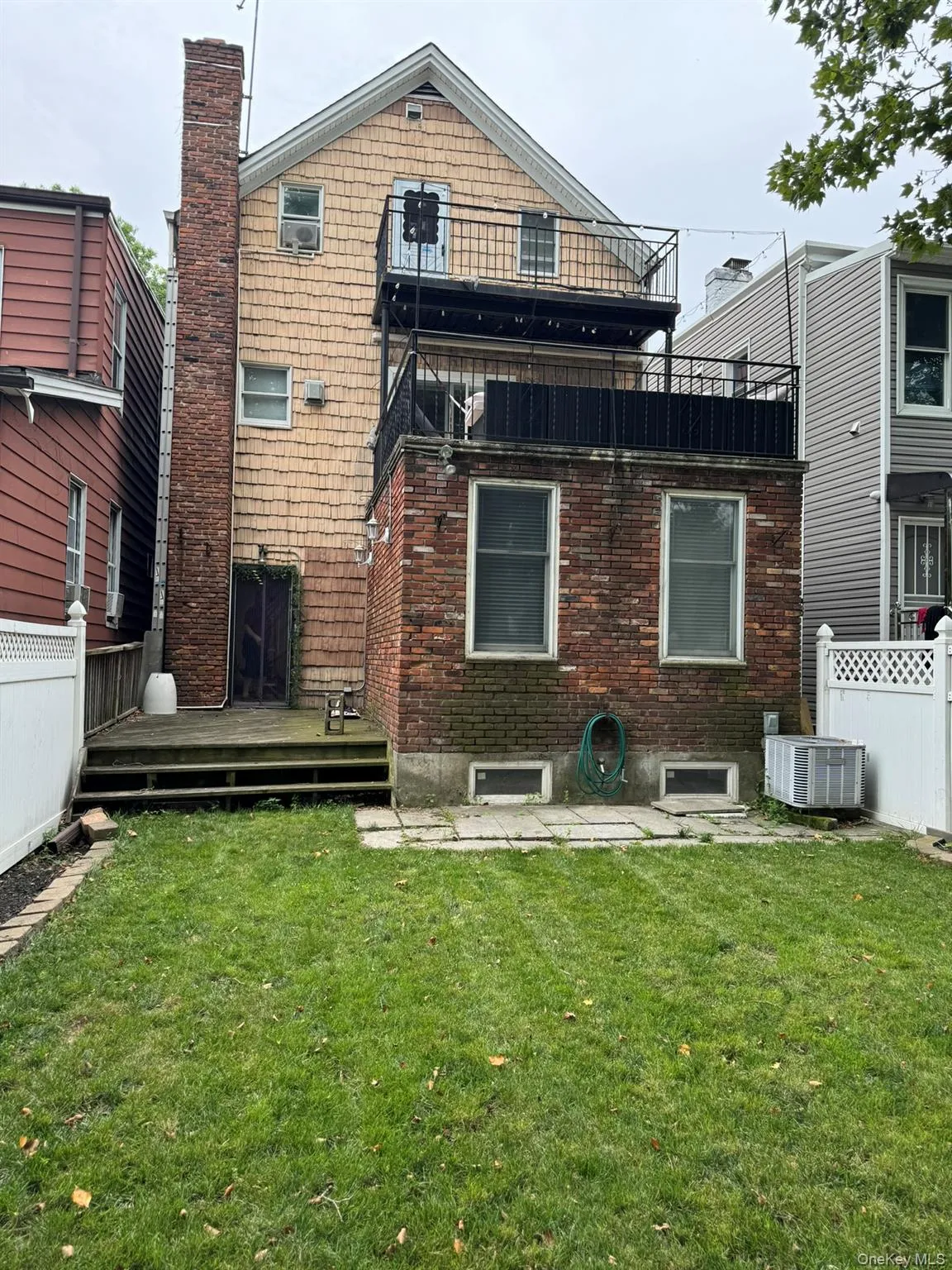 Rear view of property featuring fence, central AC, and a yard Rear view of property featuring fence, central AC, and a yard