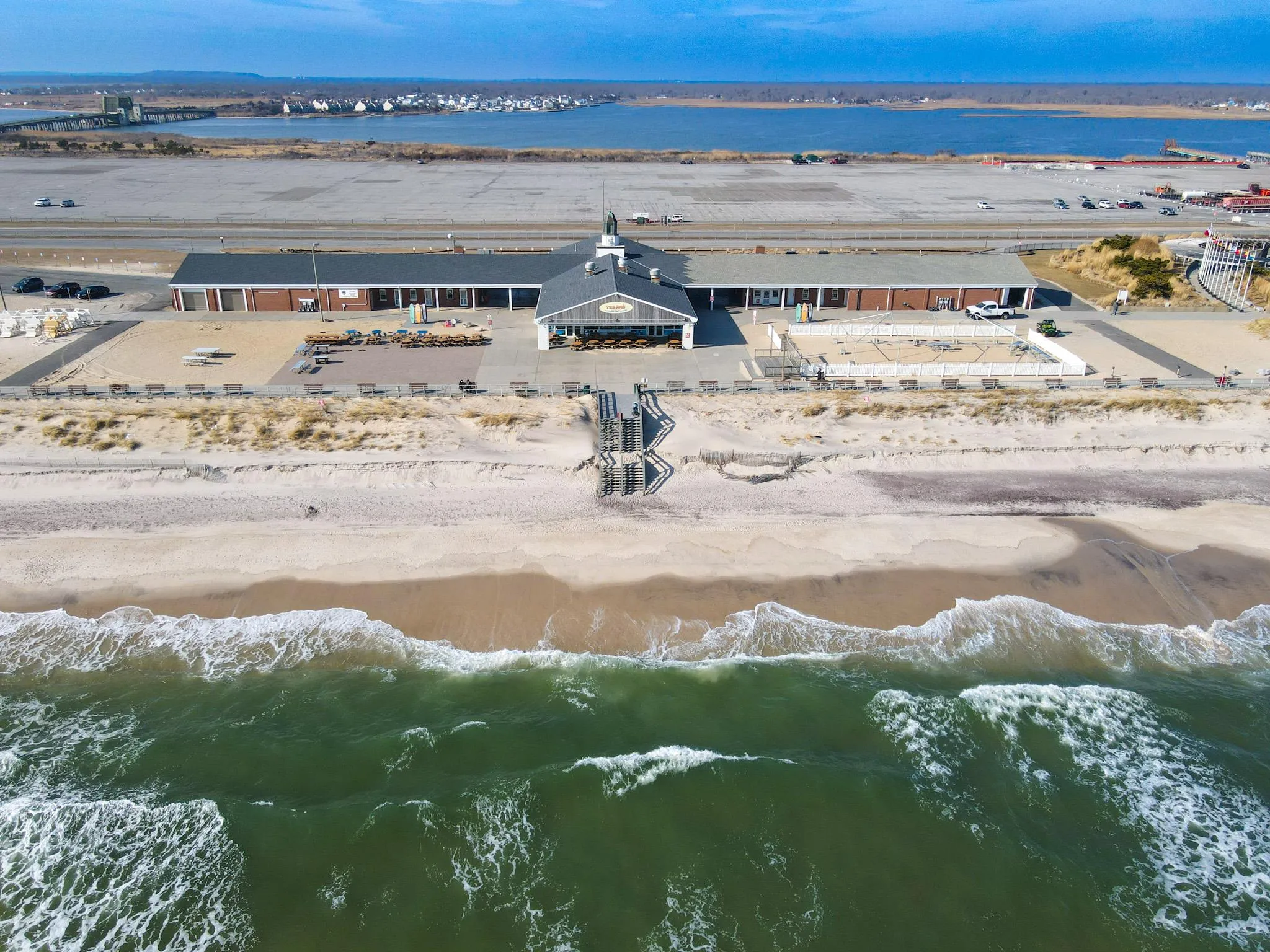 Birds eye view of property with a water view and a beach view Birds eye view of property with a water view and a beach view