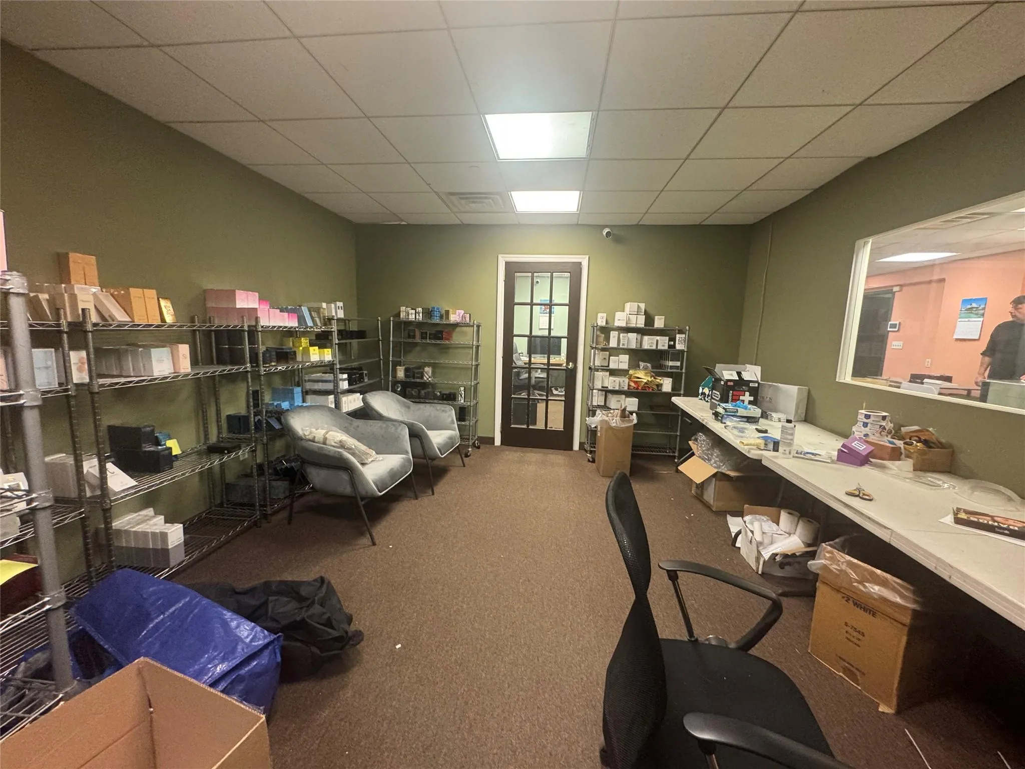 Office area featuring carpet floors and a paneled ceiling Office area featuring carpet floors and a paneled ceiling