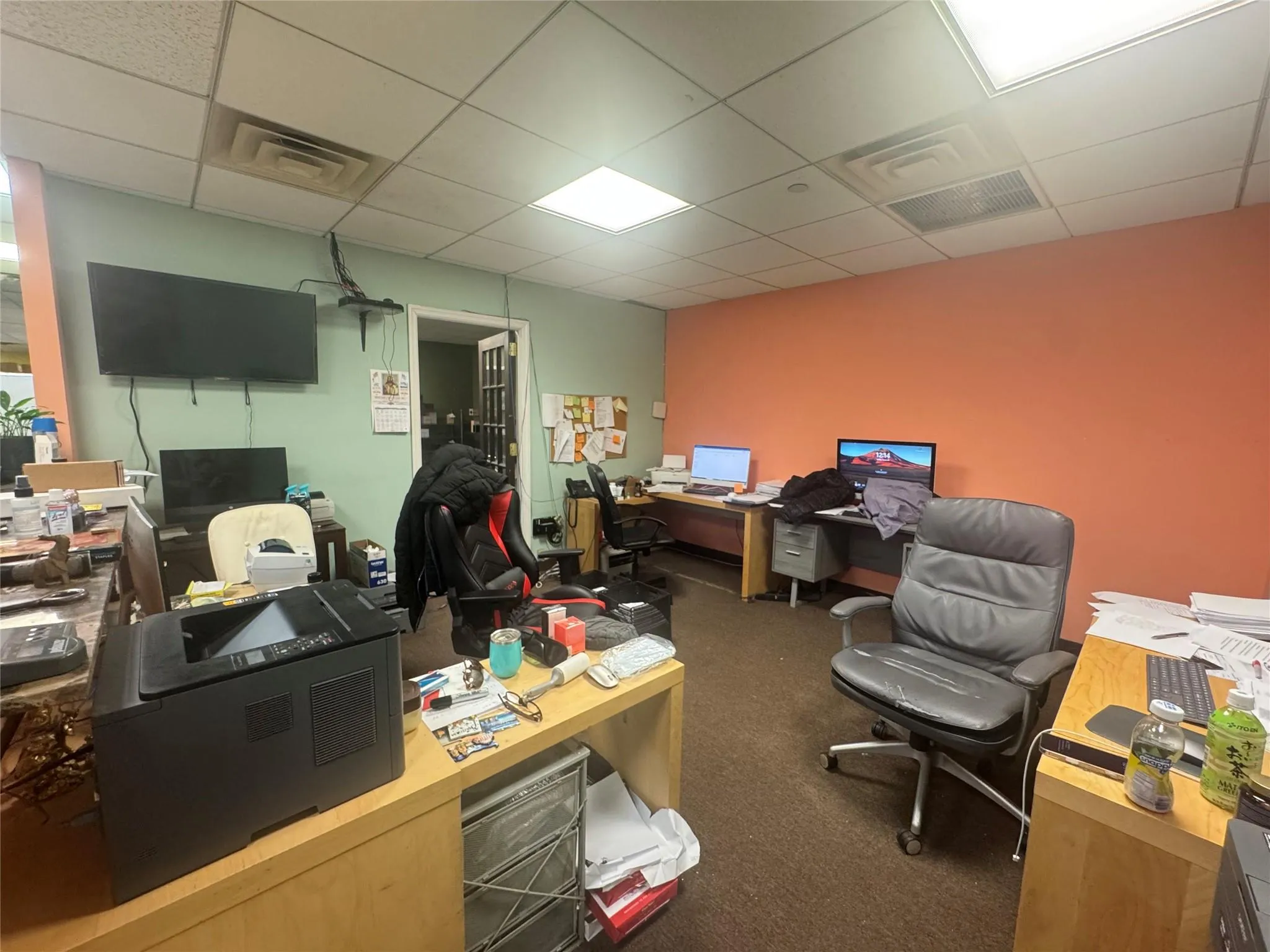 Carpeted home office featuring a paneled ceiling and visible vents Carpeted home office featuring a paneled ceiling and visible vents
