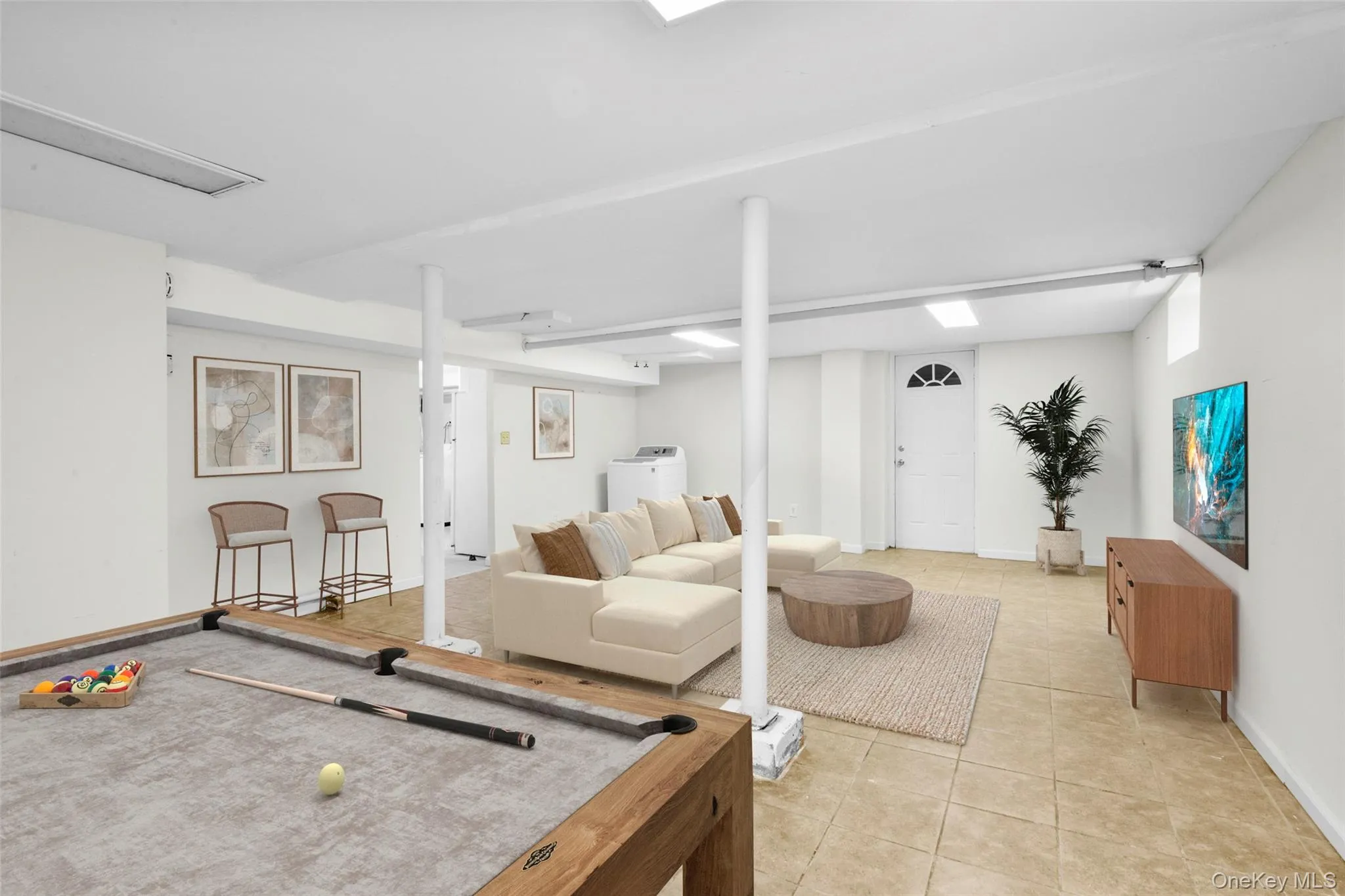 Recreation room with light tile patterned floors and billiards Recreation room with light tile patterned floors and billiards