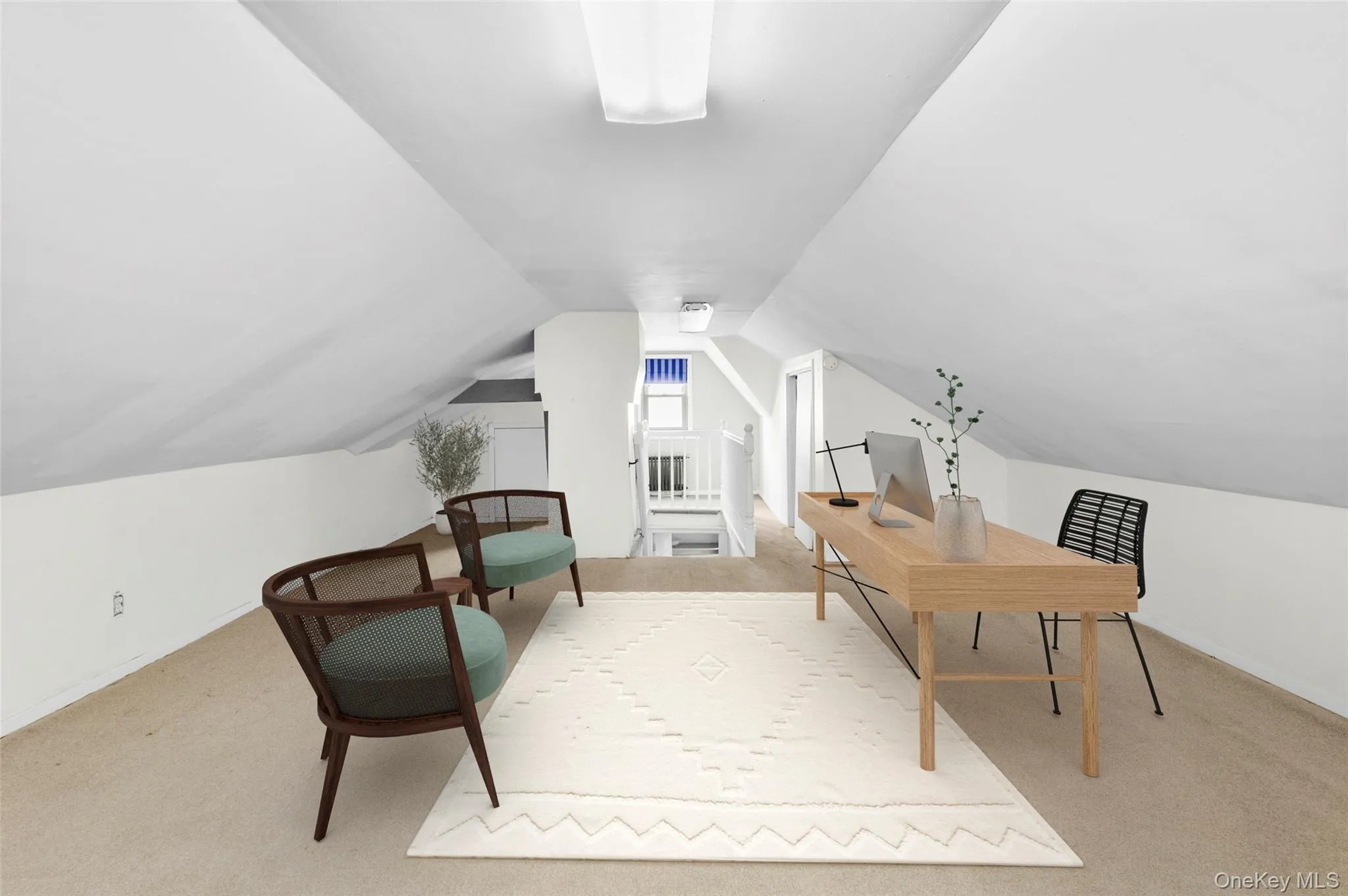 Office area featuring light carpet and lofted ceiling Office area featuring light carpet and lofted ceiling