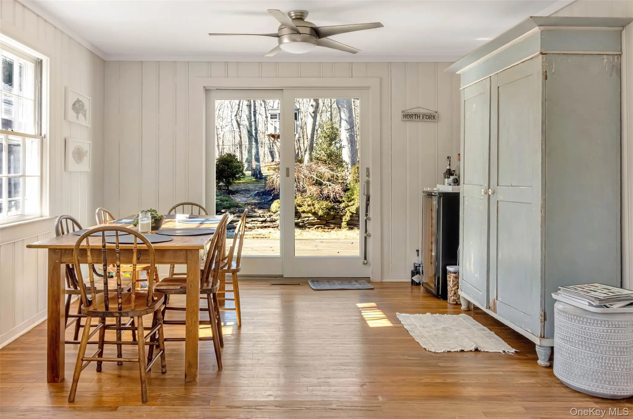 Dining area with crown molding, plenty of natural light, light wood finished floors, and a ceiling fan Dining area with crown molding, plenty of natural light, light wood finished floors, and a ceiling fan