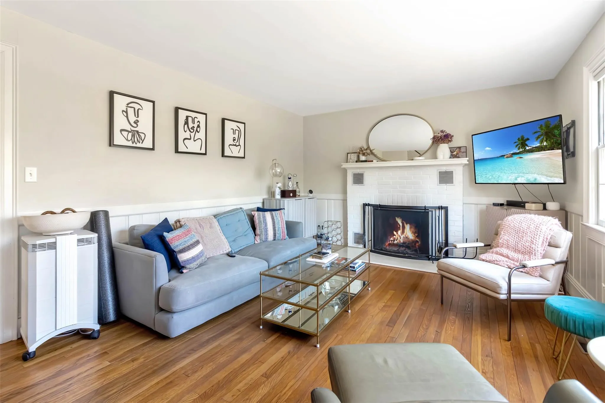 Living room featuring a fireplace and wood finished floors Living room featuring a fireplace and wood finished floors