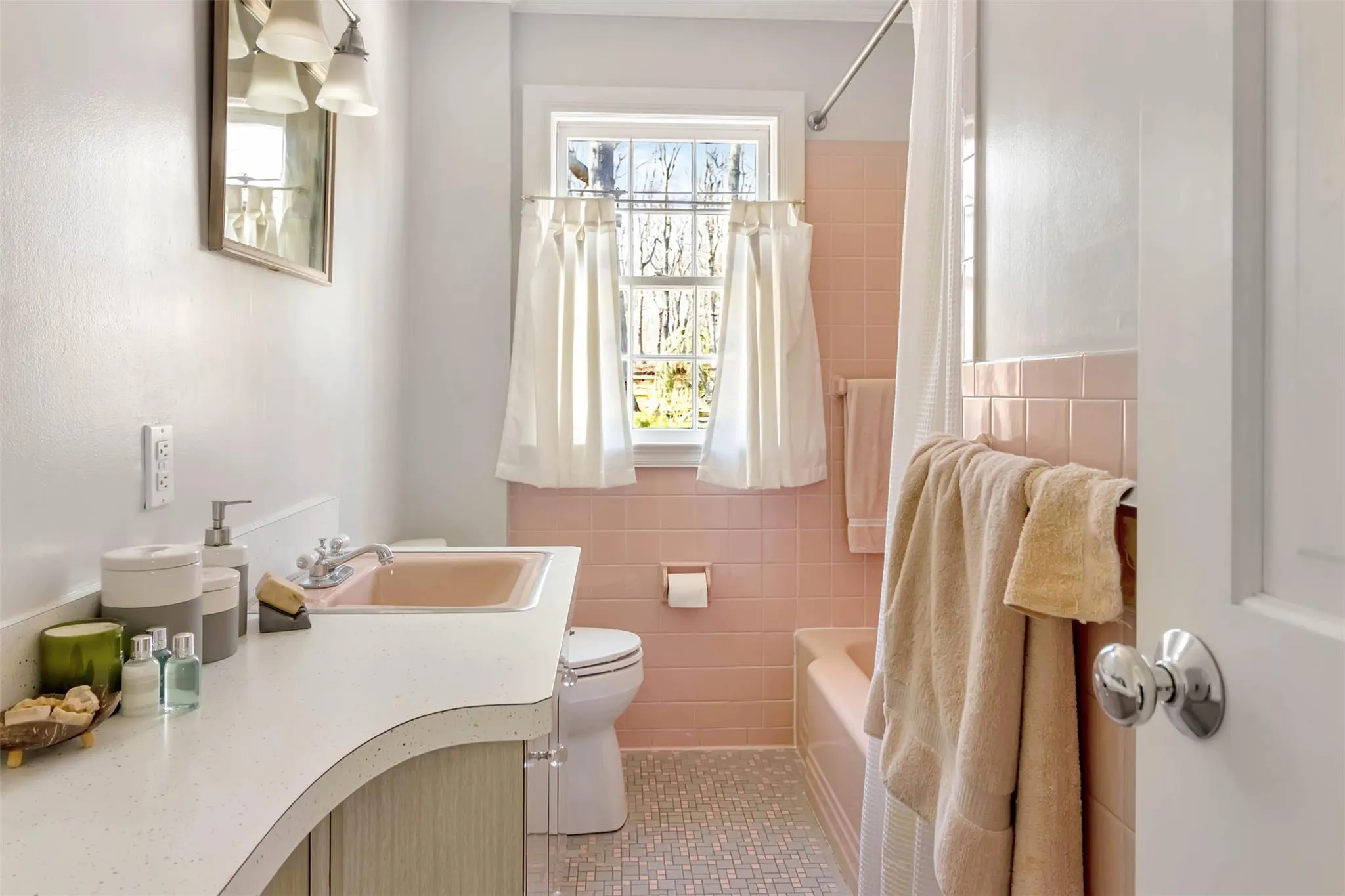 Full bathroom with shower / tub combo, toilet, tile patterned floors, vanity, and tile walls Full bathroom with shower / tub combo, toilet, tile patterned floors, vanity, and tile walls