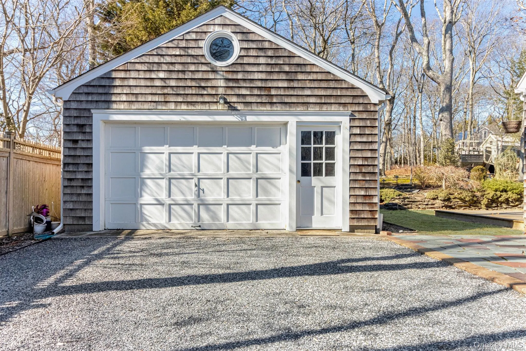 Detached garage featuring fence Detached garage featuring fence