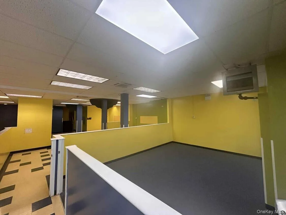 Below grade area with a paneled ceiling and a heating unit Below grade area with a paneled ceiling and a heating unit