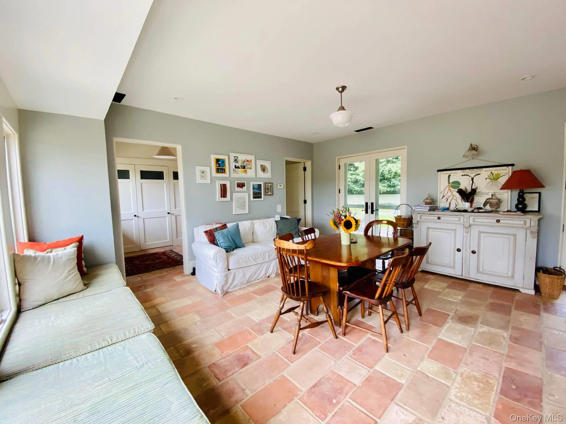 Dining area featuring stone finish floor, visible vents, and french doors Dining area featuring stone finish floor, visible vents, and french doors