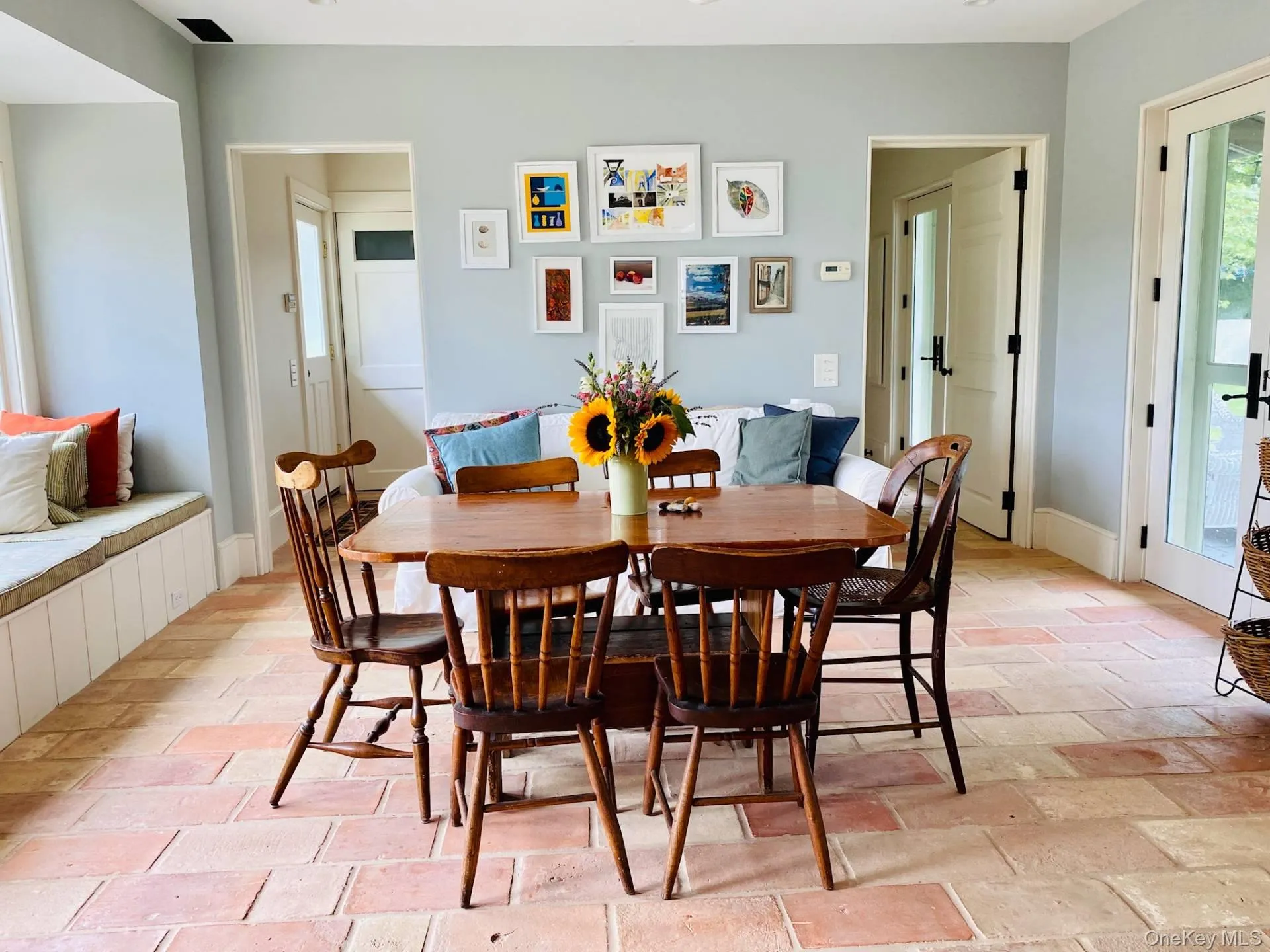 Dining space featuring brick floor and baseboards Dining space featuring brick floor and baseboards