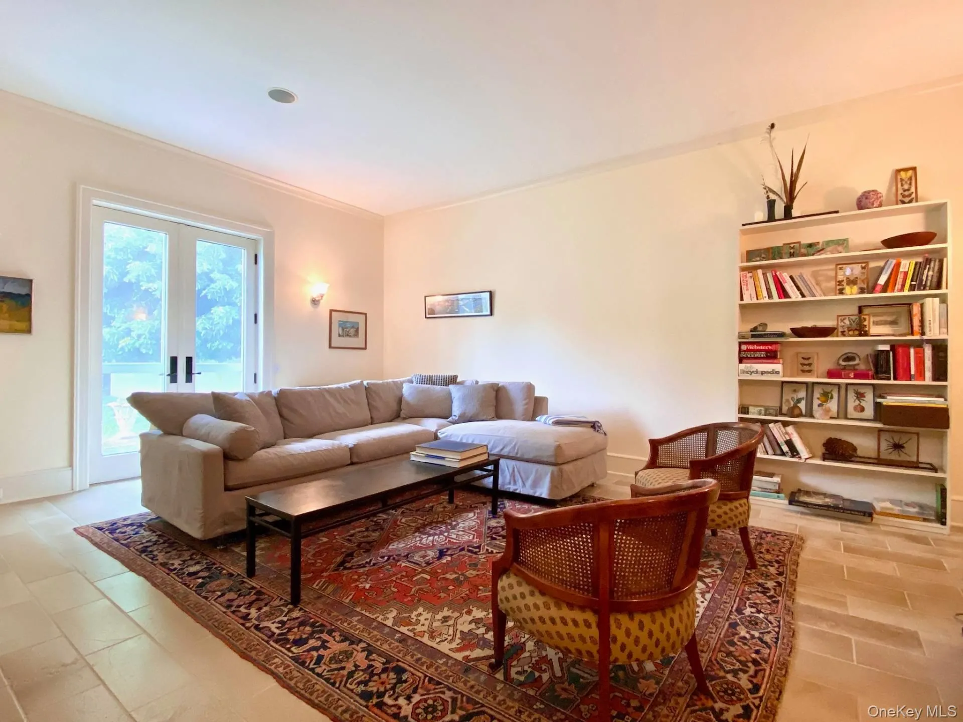 Living room featuring baseboards, ornamental molding, and french doors Living room featuring baseboards, ornamental molding, and french doors