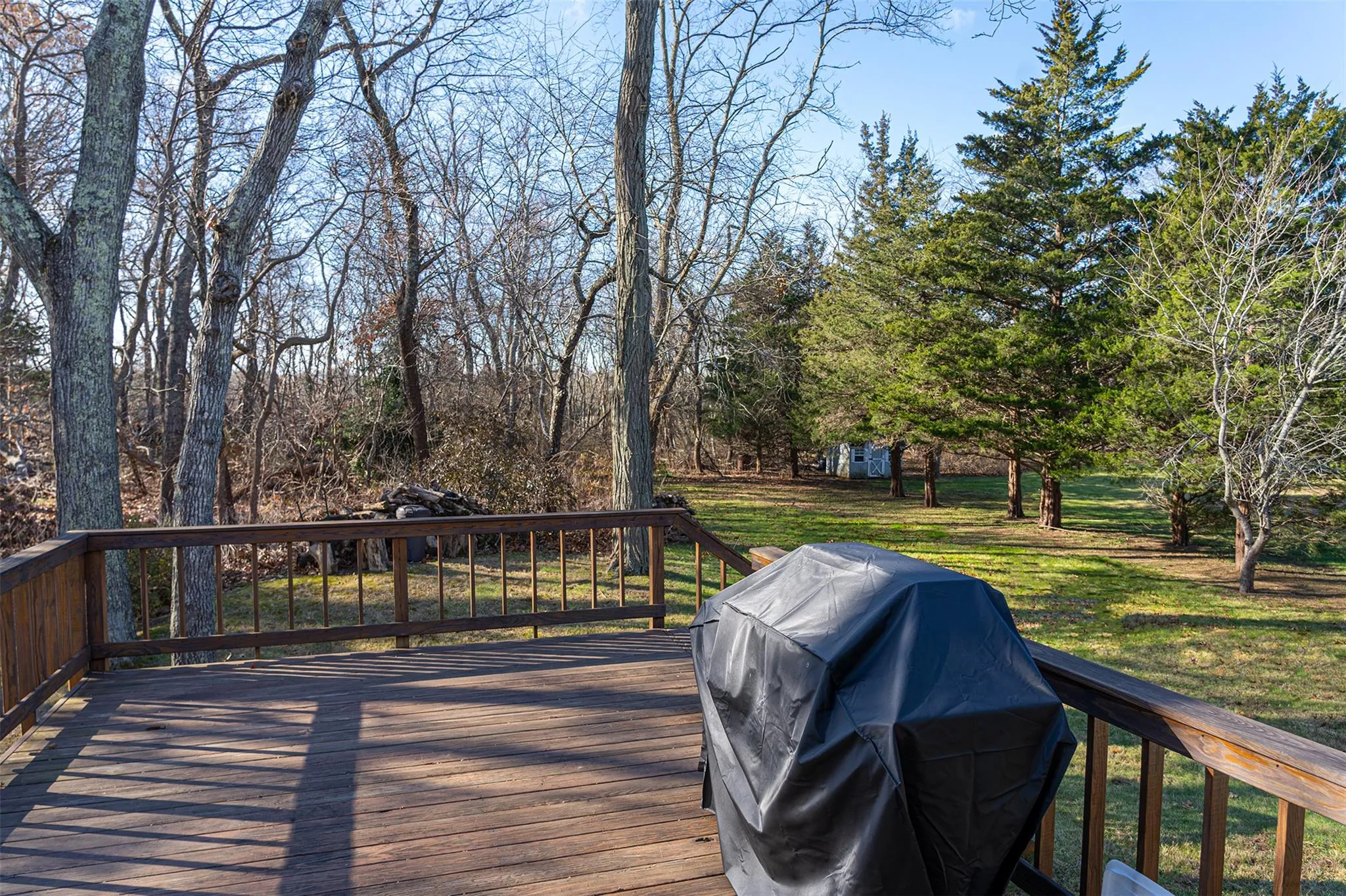 Wooden terrace featuring a lawn and area for grilling Wooden terrace featuring a lawn and area for grilling