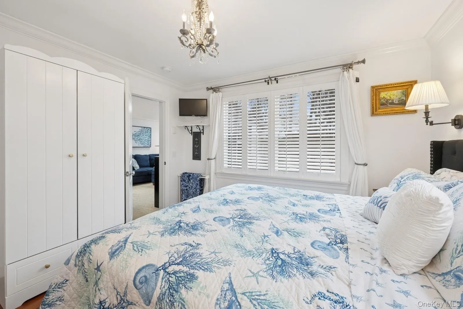 Bedroom featuring a notable chandelier, a closet, and crown molding Bedroom featuring a notable chandelier, a closet, and crown molding