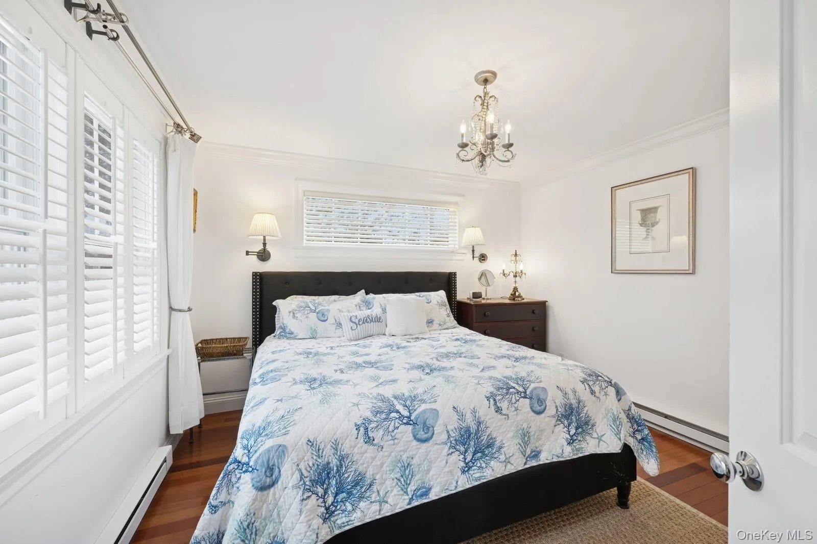Bedroom featuring multiple windows, a baseboard radiator, and crown molding Bedroom featuring multiple windows, a baseboard radiator, and crown molding