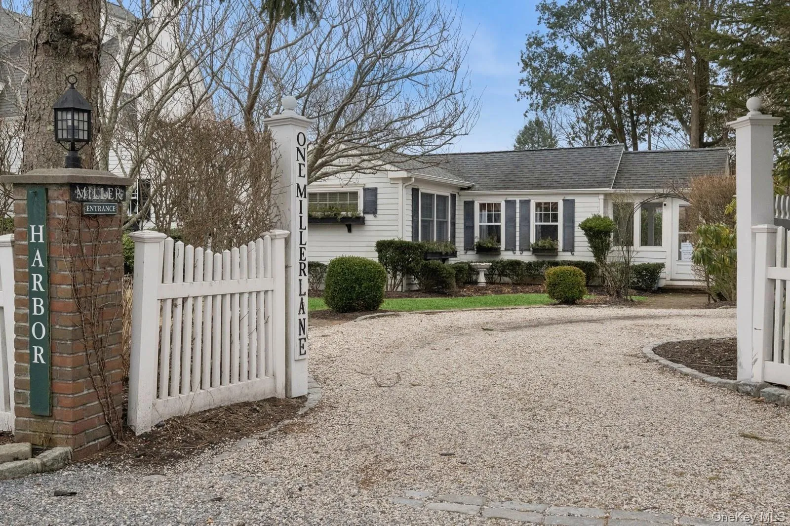 View of front of house with driveway, a gate, fence, and roof with shingles View of front of house with driveway, a gate, fence, and roof with shingles