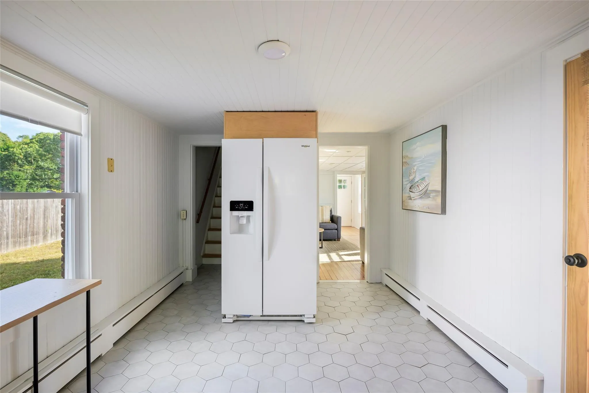 Kitchen with a baseboard heating unit and white refrigerator with ice dispenser Kitchen with a baseboard heating unit and white refrigerator with ice dispenser