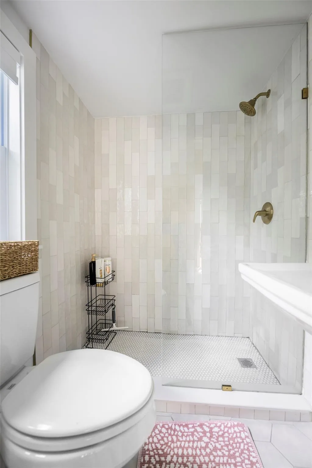 Full bathroom with tiled shower, tile walls, and toilet Full bathroom with tiled shower, tile walls, and toilet