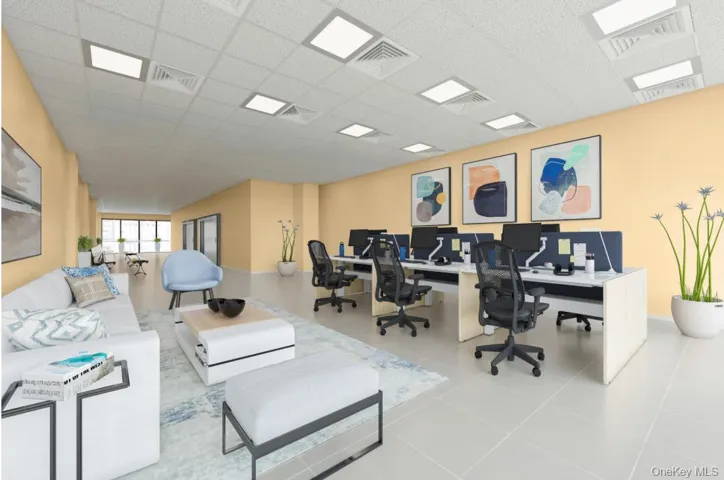 Office space with a paneled ceiling, visible vents, and tile patterned floors