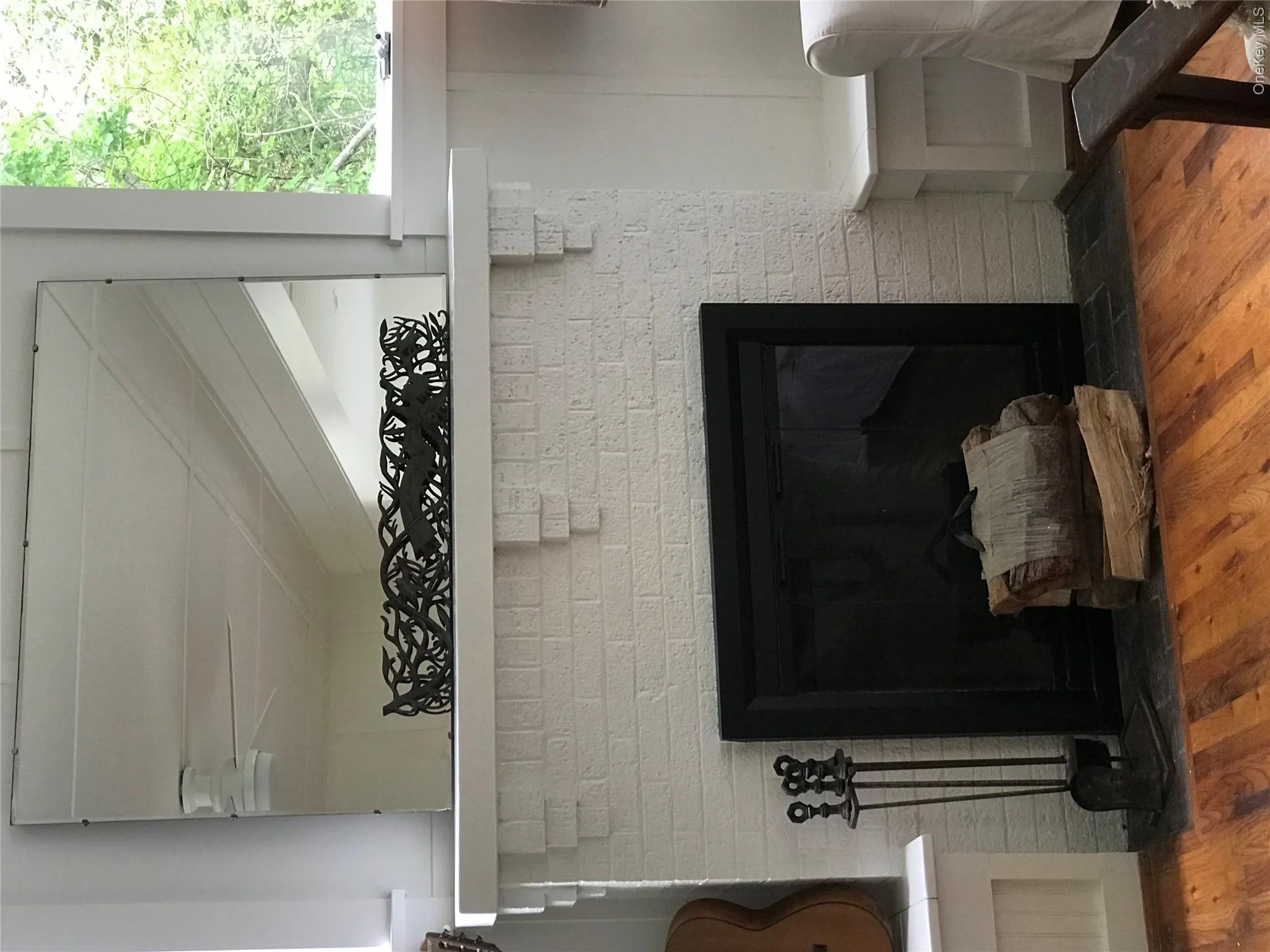 Interior details featuring ceiling fan, a fireplace, and wood finished floors Interior details featuring ceiling fan, a fireplace, and wood finished floors