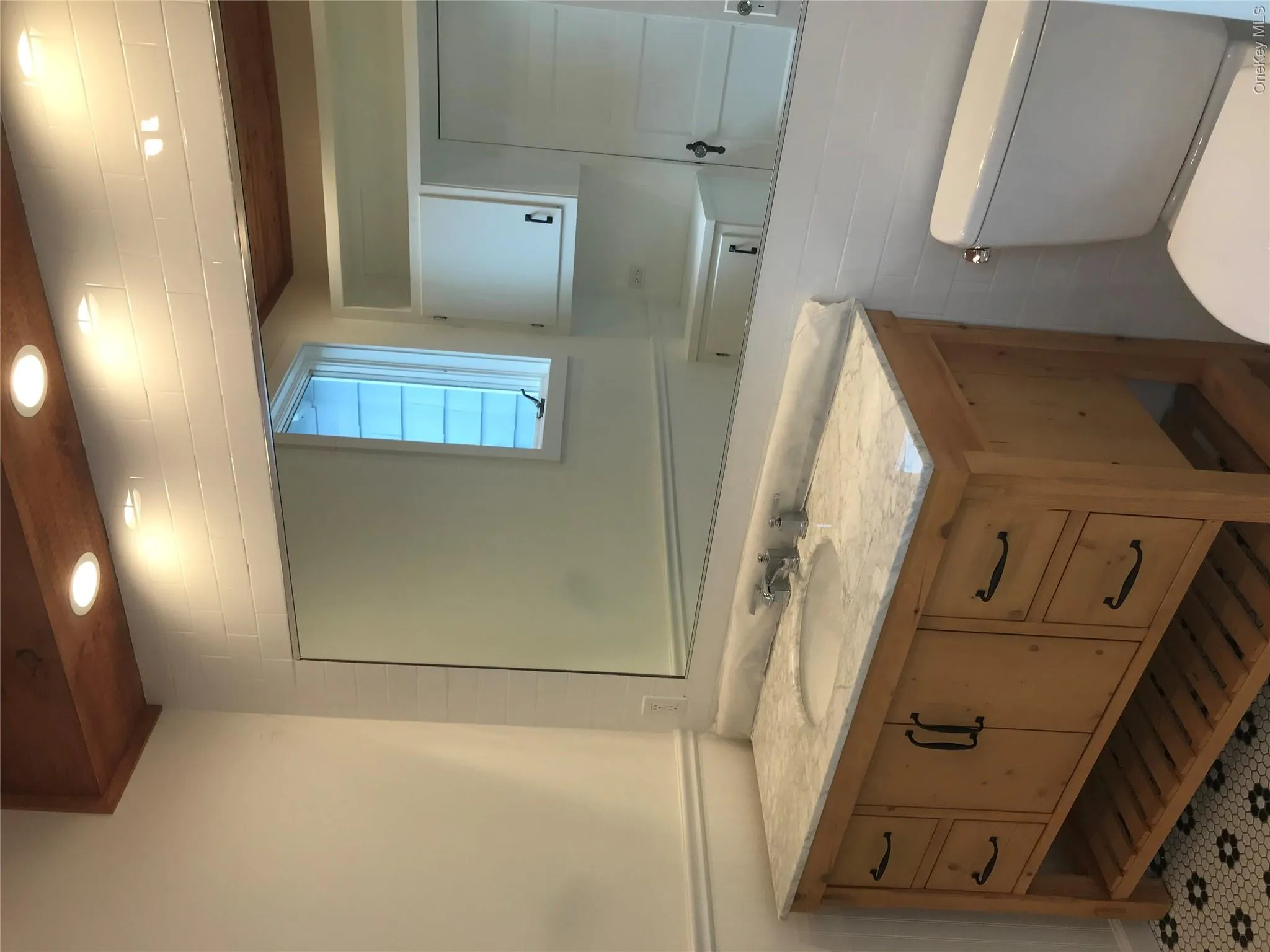 Half bath with recessed lighting, wainscoting, vanity, and toilet Half bath with recessed lighting, wainscoting, vanity, and toilet