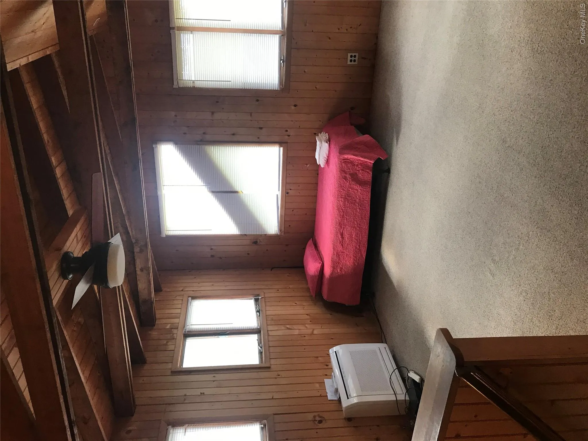 Carpeted bedroom with wooden walls, wood ceiling, and lofted ceiling with beams Carpeted bedroom with wooden walls, wood ceiling, and lofted ceiling with beams
