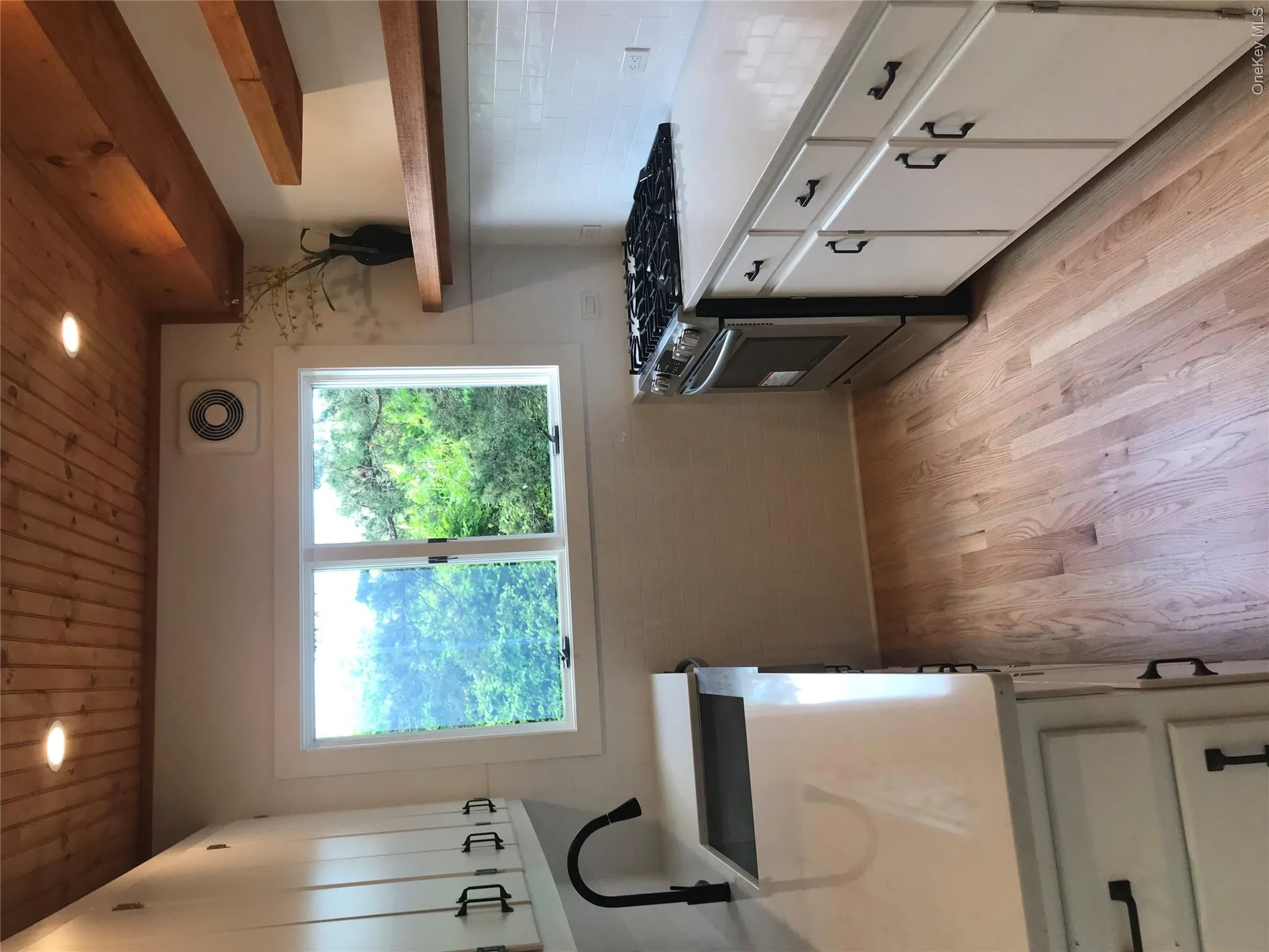 Kitchen featuring open shelves, stove, light wood-style floors, a sink, and wooden ceiling Kitchen featuring open shelves, stove, light wood-style floors, a sink, and wooden ceiling