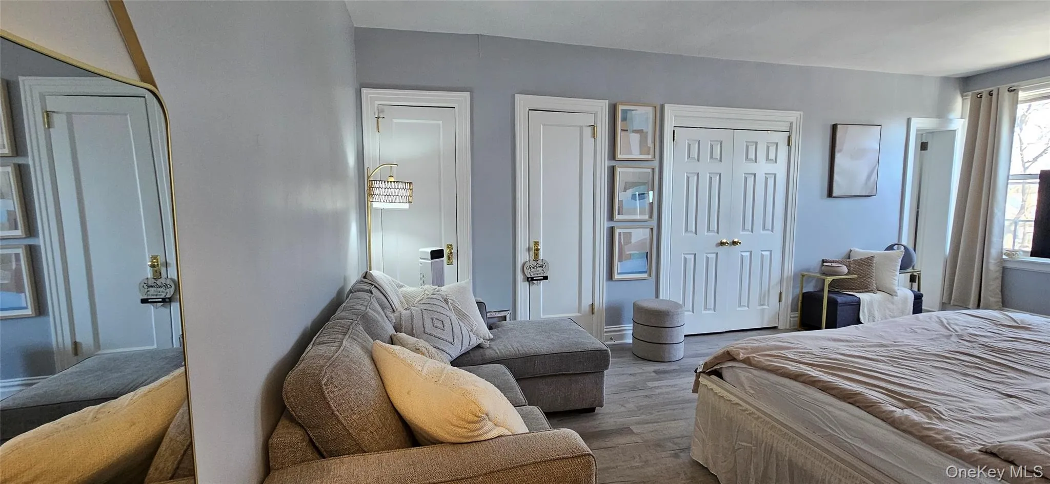 Bedroom featuring wood finished floors and multiple closets Bedroom featuring wood finished floors and multiple closets