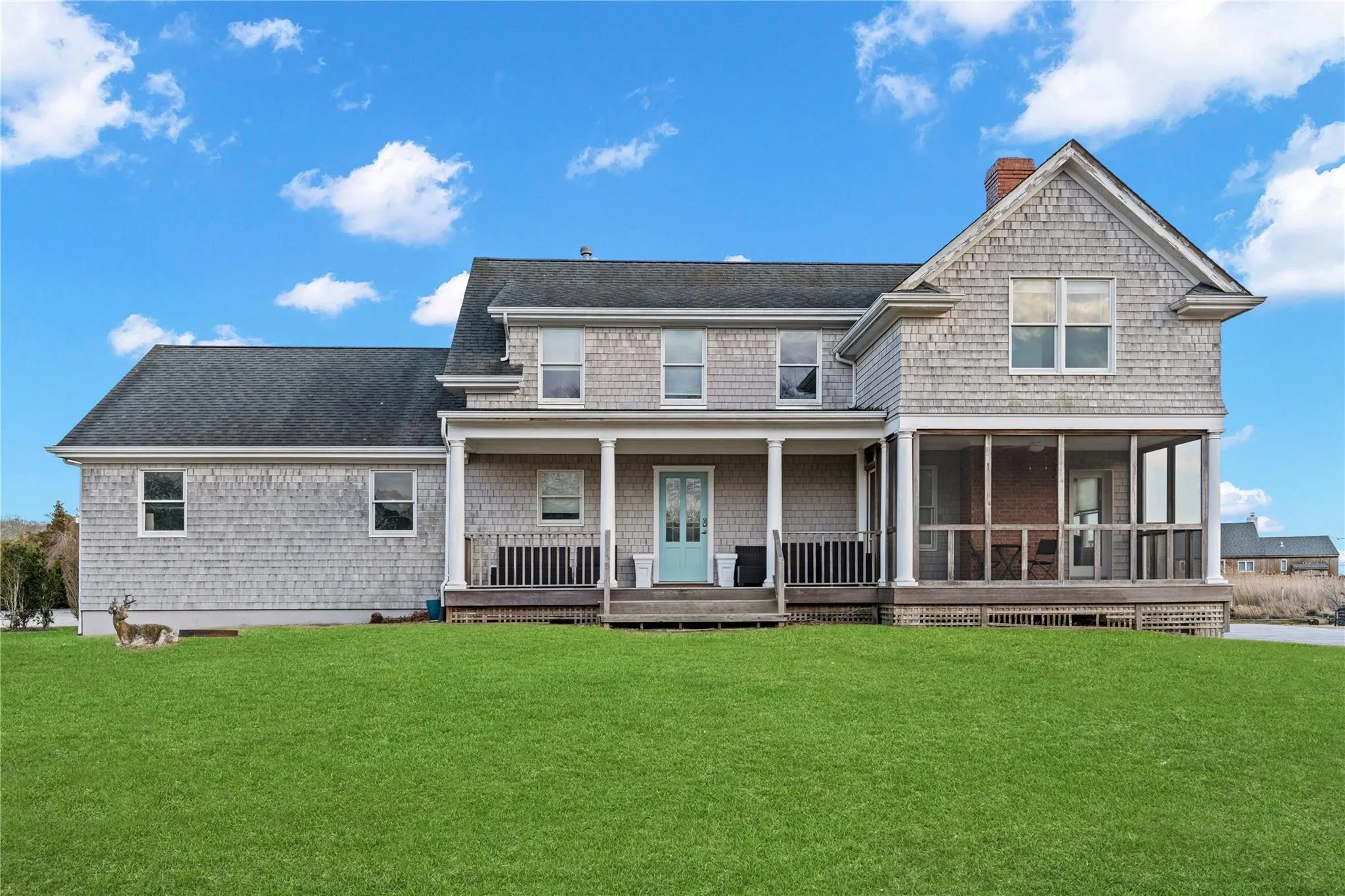 Large grass yard,  a shingled roof, a chimney, and a screened porch Large grass yard,  a shingled roof, a chimney, and a screened porch