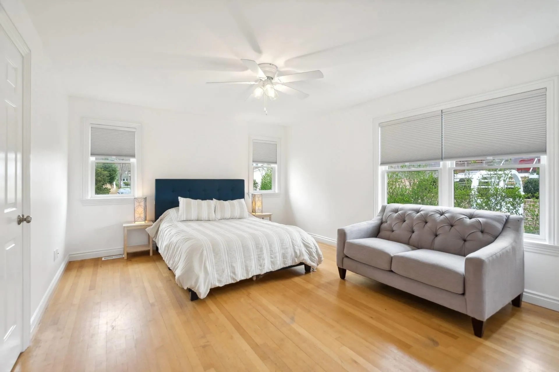 Guest Bed 2 of 4 with ceiling fan, light wood-style flooring, and beautiful views Guest Bed 2 of 4 with ceiling fan, light wood-style flooring, and beautiful views