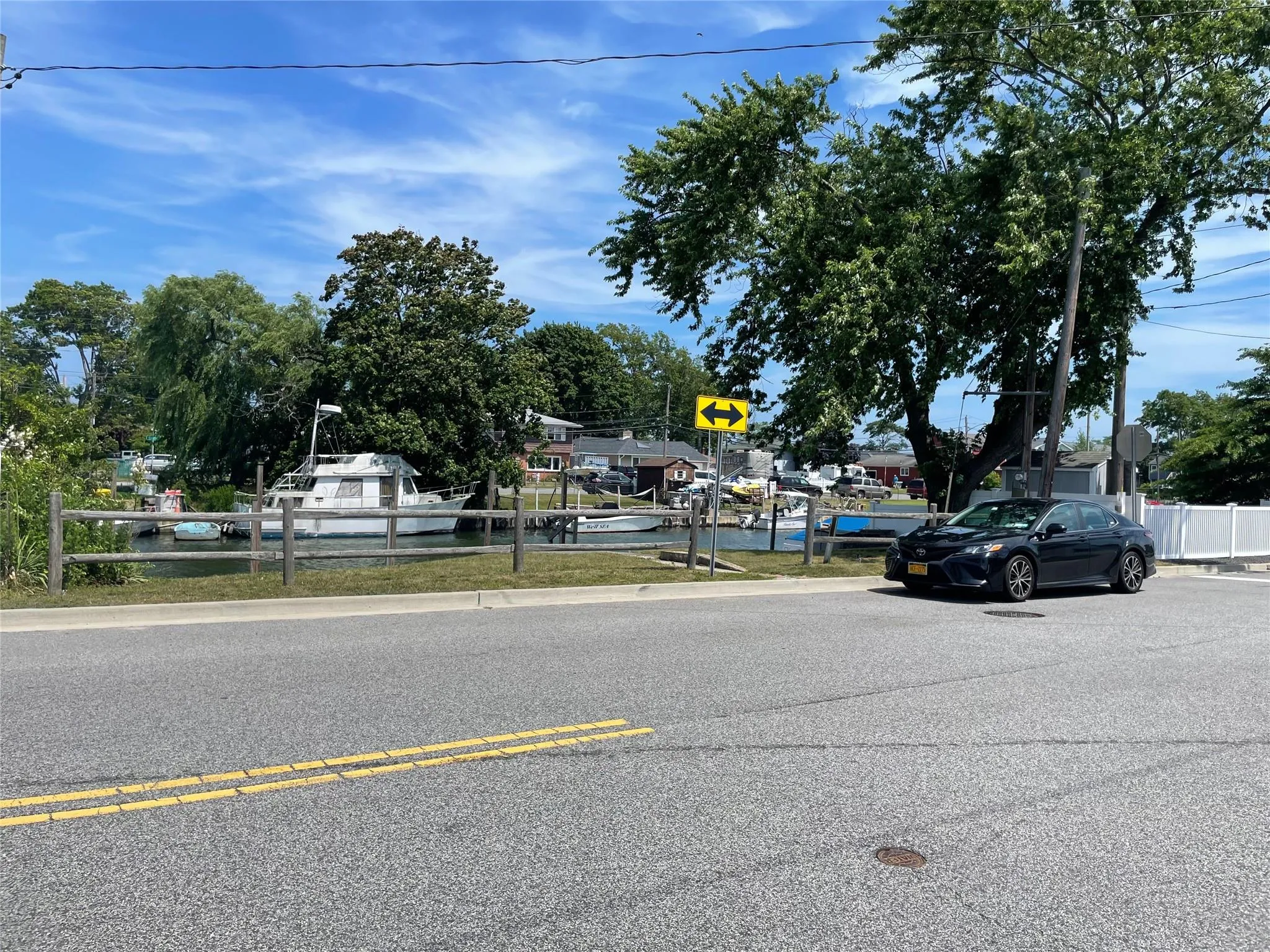 View of road featuring curbs and traffic signs View of road featuring curbs and traffic signs