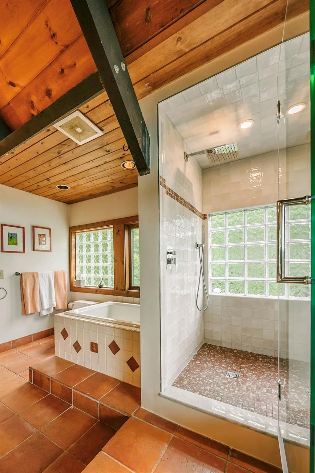 Primary bathroom featuring a healthy amount of sunlight, a shower and bath Primary bathroom featuring a healthy amount of sunlight, a shower and bath