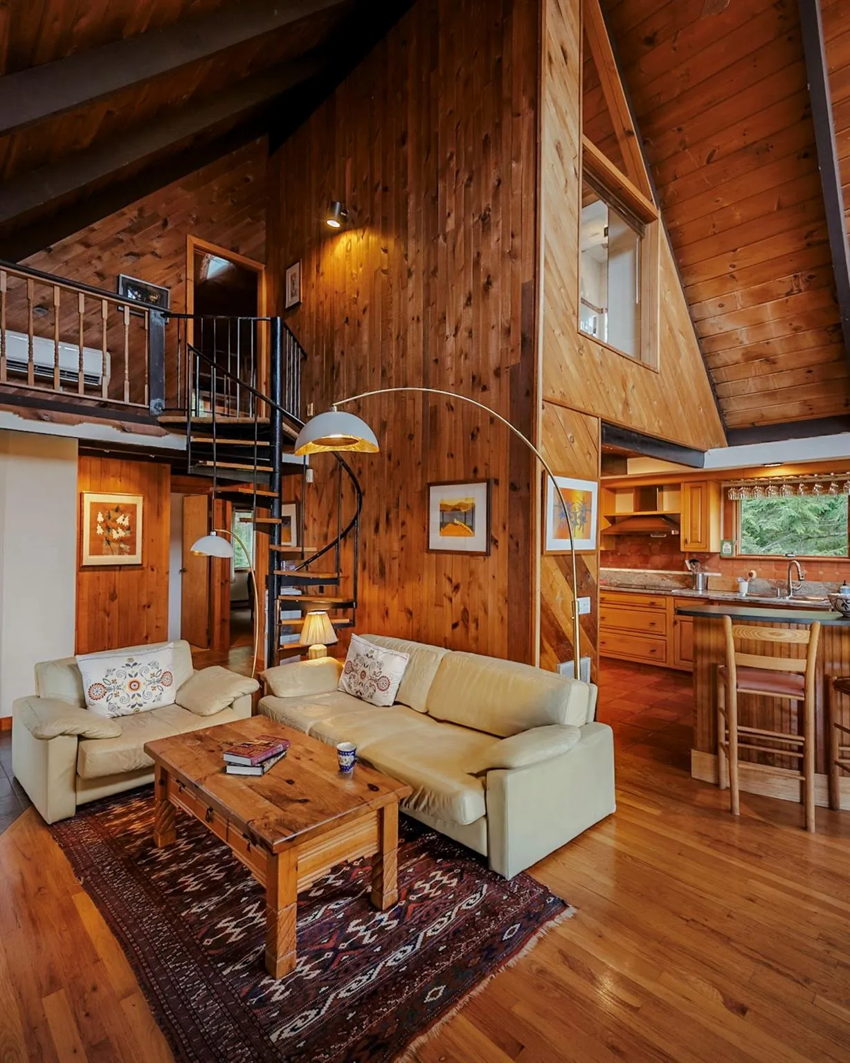 Living room featuring wooden ceiling, stairway, wood finished floors, wood walls, and high vaulted ceiling Living room featuring wooden ceiling, stairway, wood finished floors, wood walls, and high vaulted ceiling