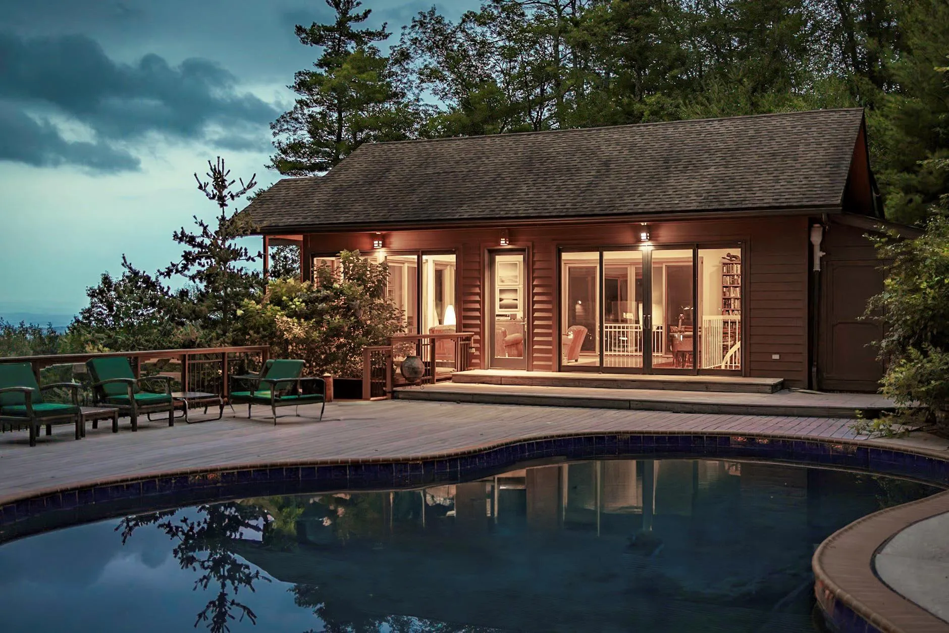 Pool overlooking pool house and deck Pool overlooking pool house and deck