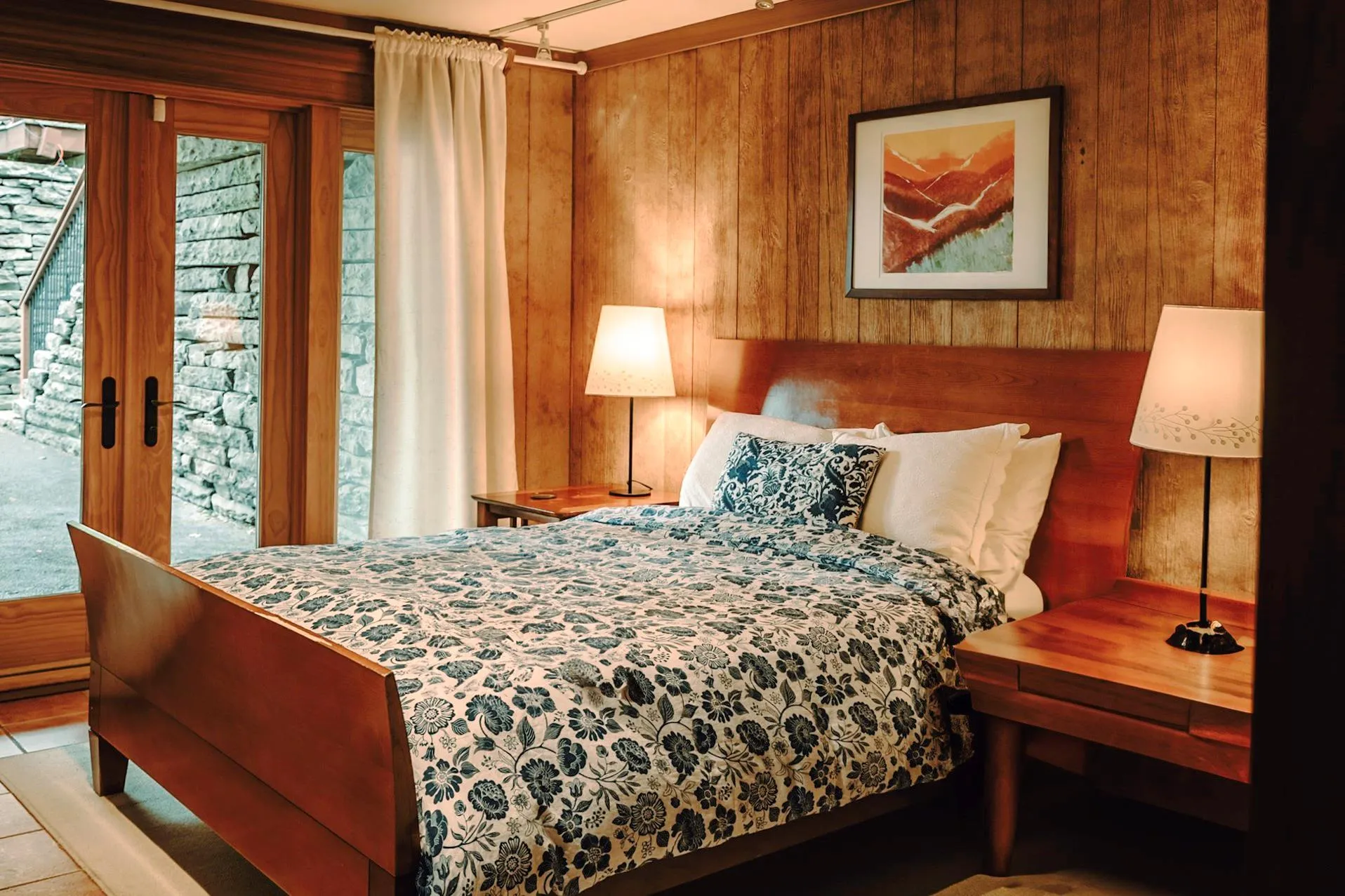 Bedroom with wood walls, access to outside Bedroom with wood walls, access to outside
