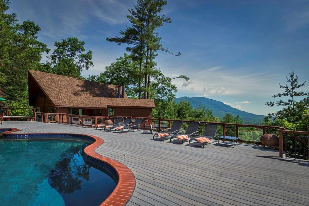 View of pool with a deck with mountain view and a fenced in pool View of pool with a deck with mountain view and a fenced in pool
