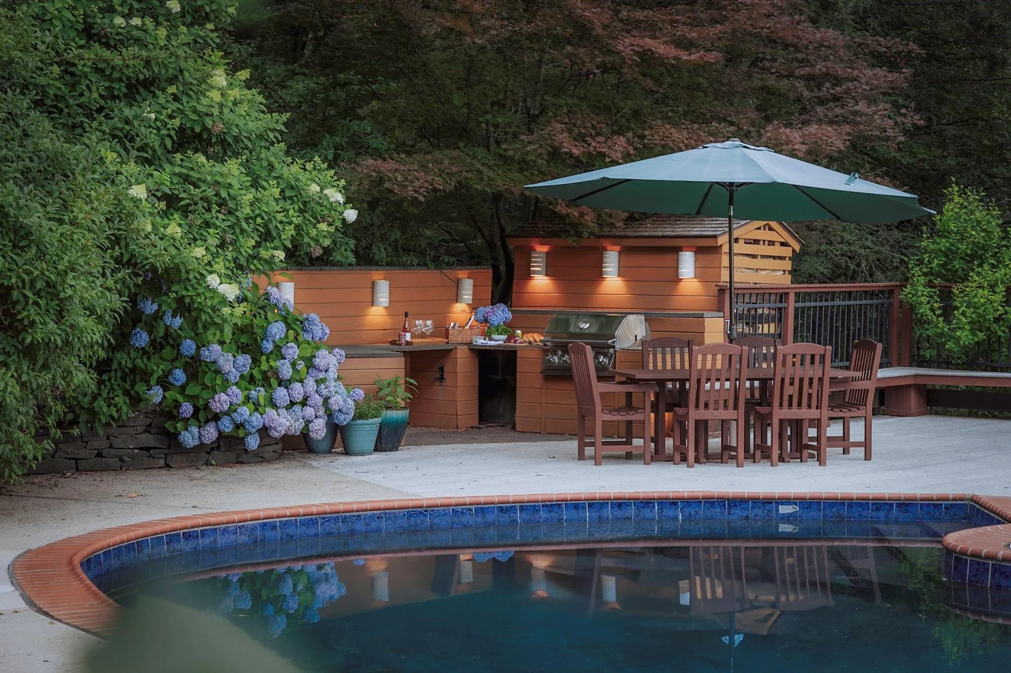 Pool featuring exterior kitchen, a patio, and grilling area Pool featuring exterior kitchen, a patio, and grilling area