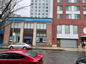 View of building exterior with a garage and aphalt driveway View of building exterior with a garage and aphalt driveway