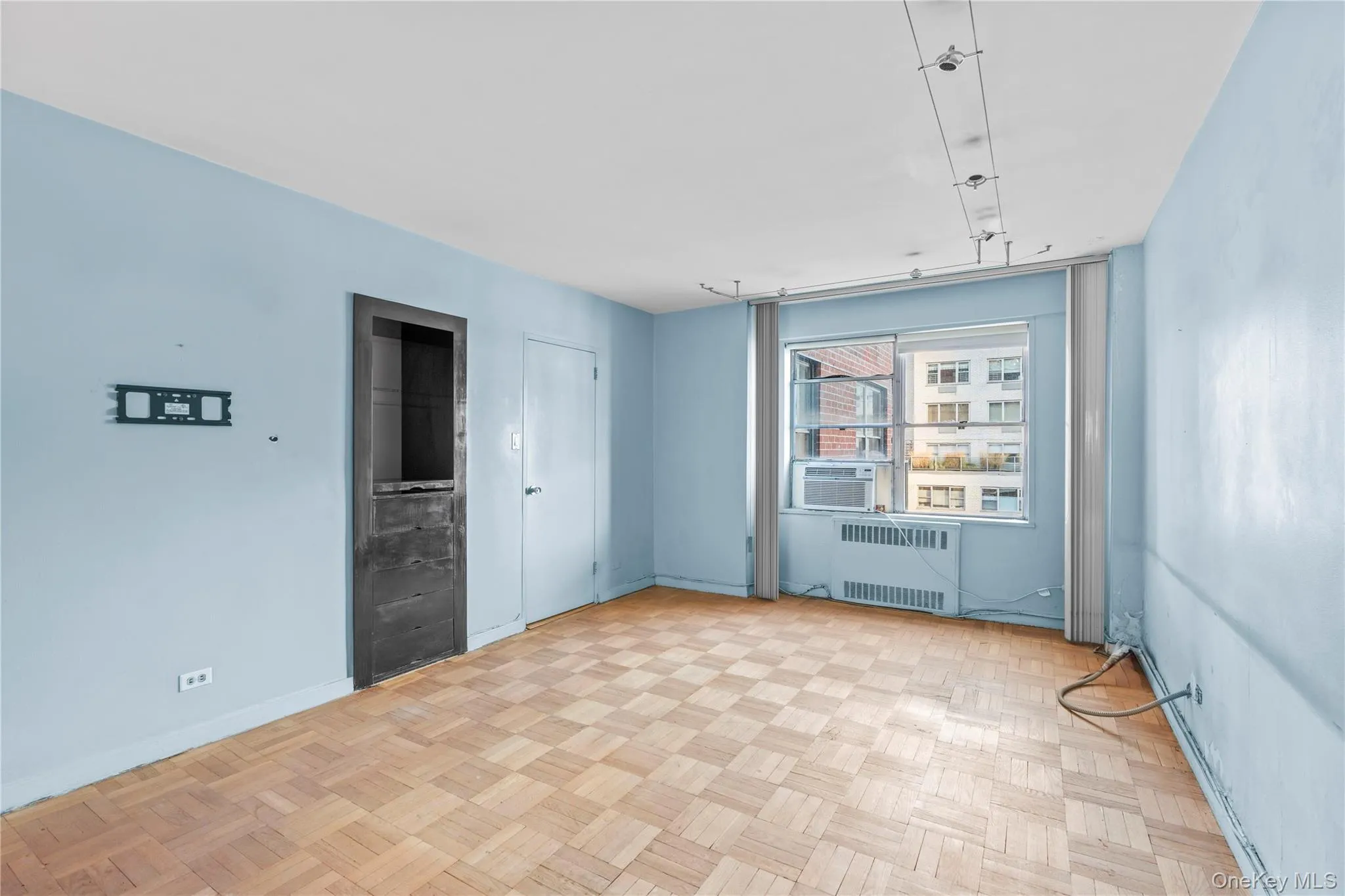 Spare room featuring cooling unit, baseboards, and radiator heating unit Spare room featuring cooling unit, baseboards, and radiator heating unit